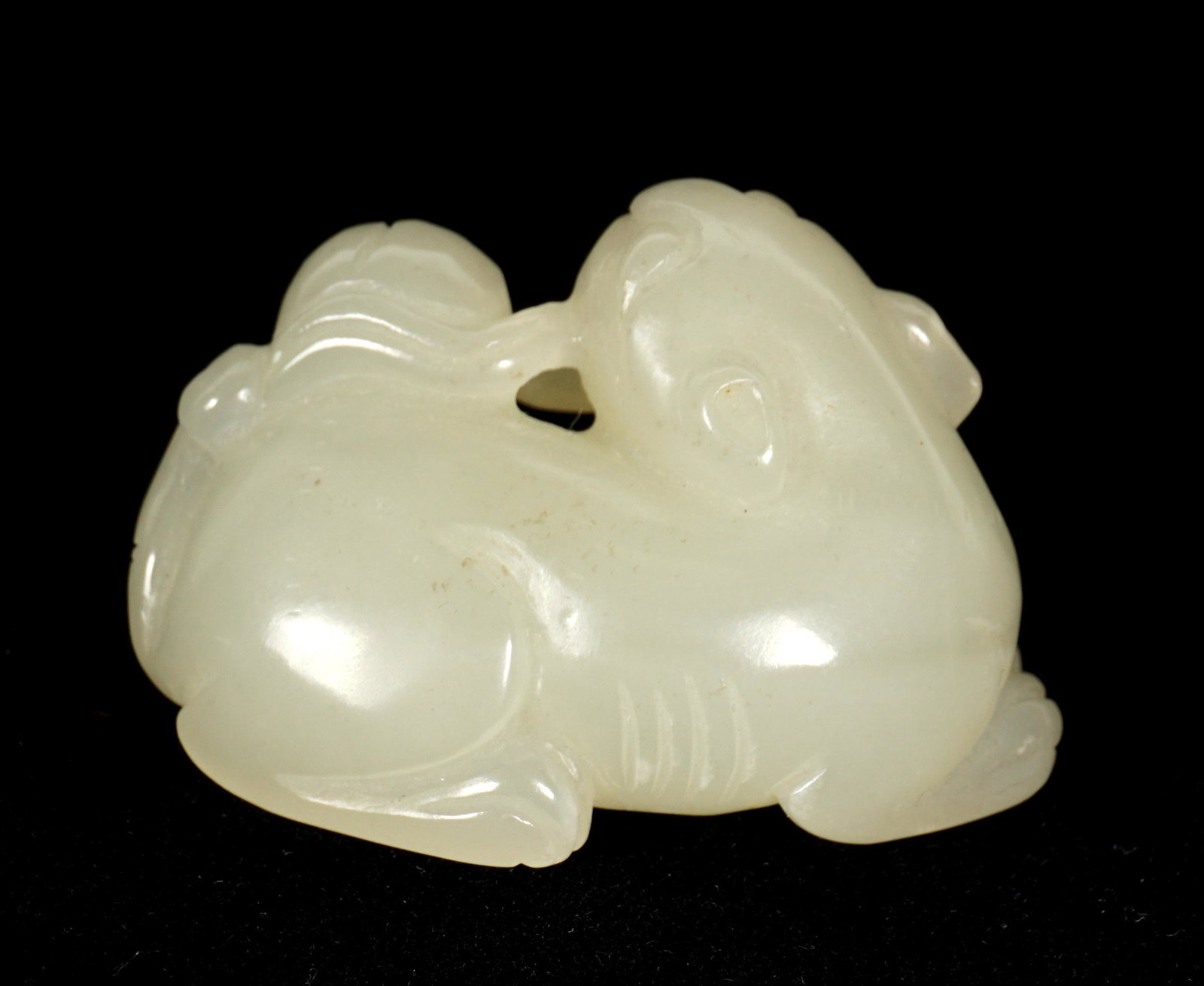 Chinese Carved White Jade Qilin: Figure of a qilin or foo dog, carved white jade, 1" h .x 1.75" x 1".