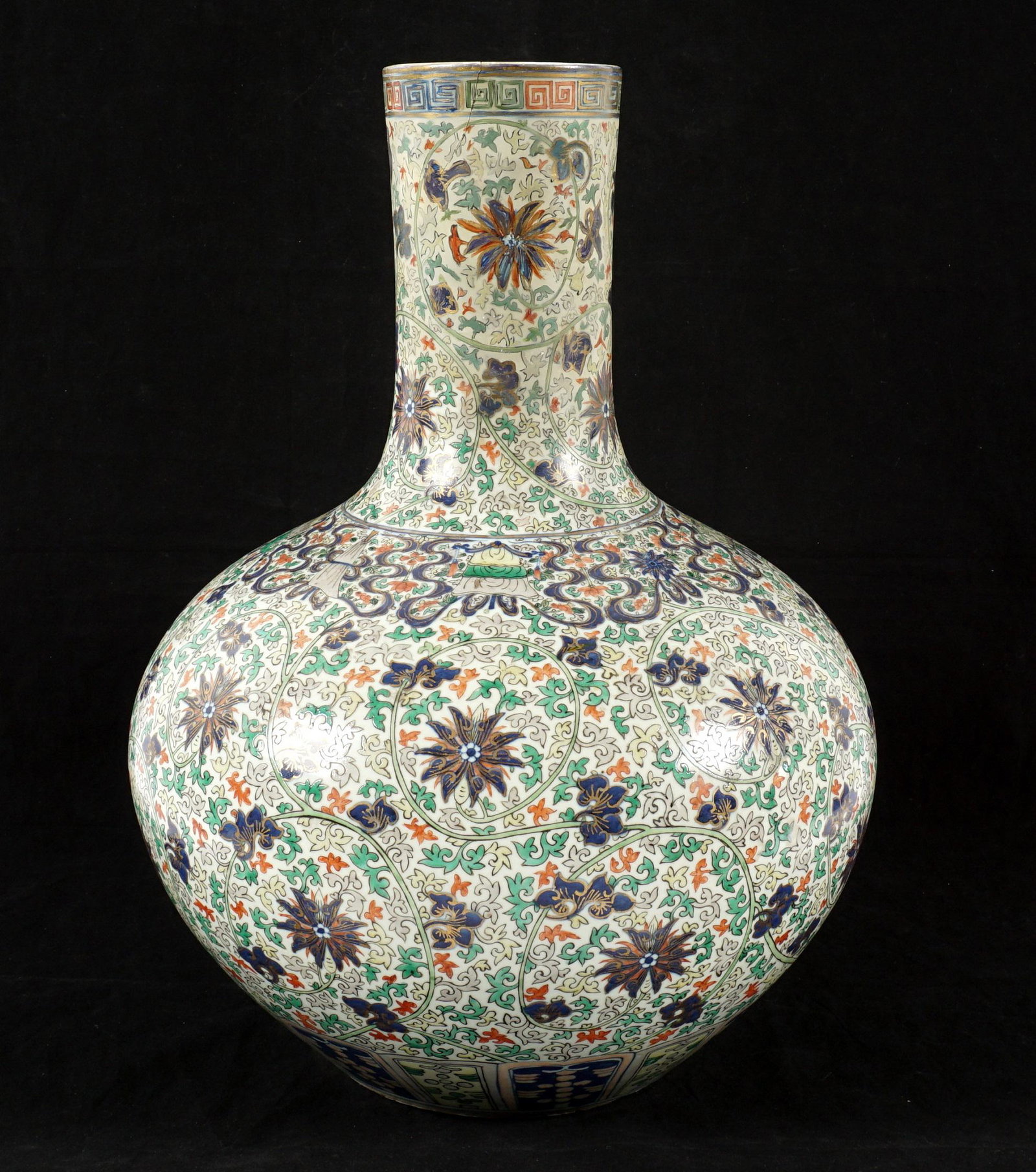 Large Chinese Polychrome Floral Vase: Large bottle form vase, floral and foliate scroll motifs, no markings, overall 20" h. x 15" dia. Condition: Extensive restoration to neck.