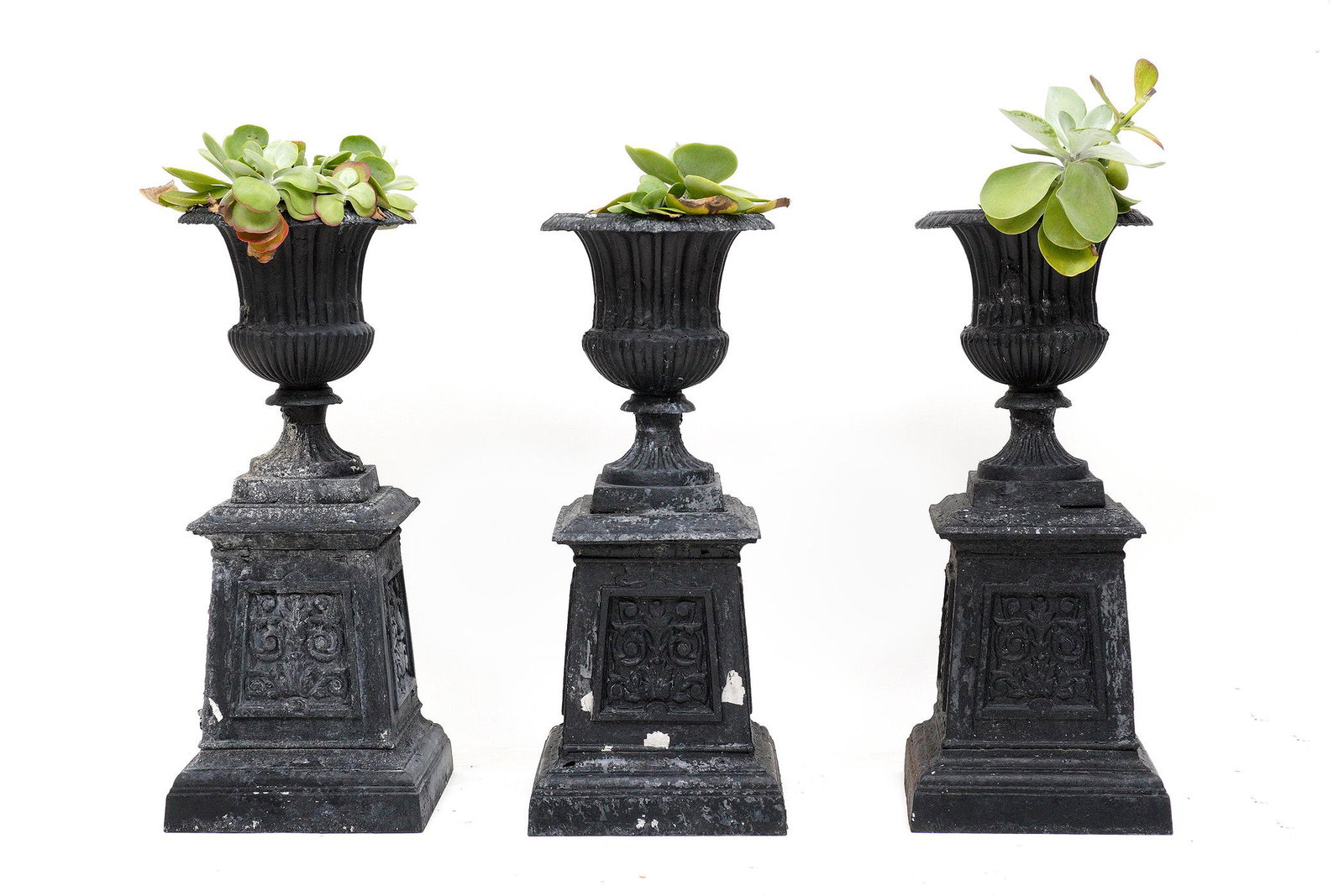 Set of Three Aluminum Garden Urn Planters: Set of three cast aluminum planters, urns on pedestal bases, overall 43.75" x 18" x 18". Condition: Obvious signs of weathering and paint flake.