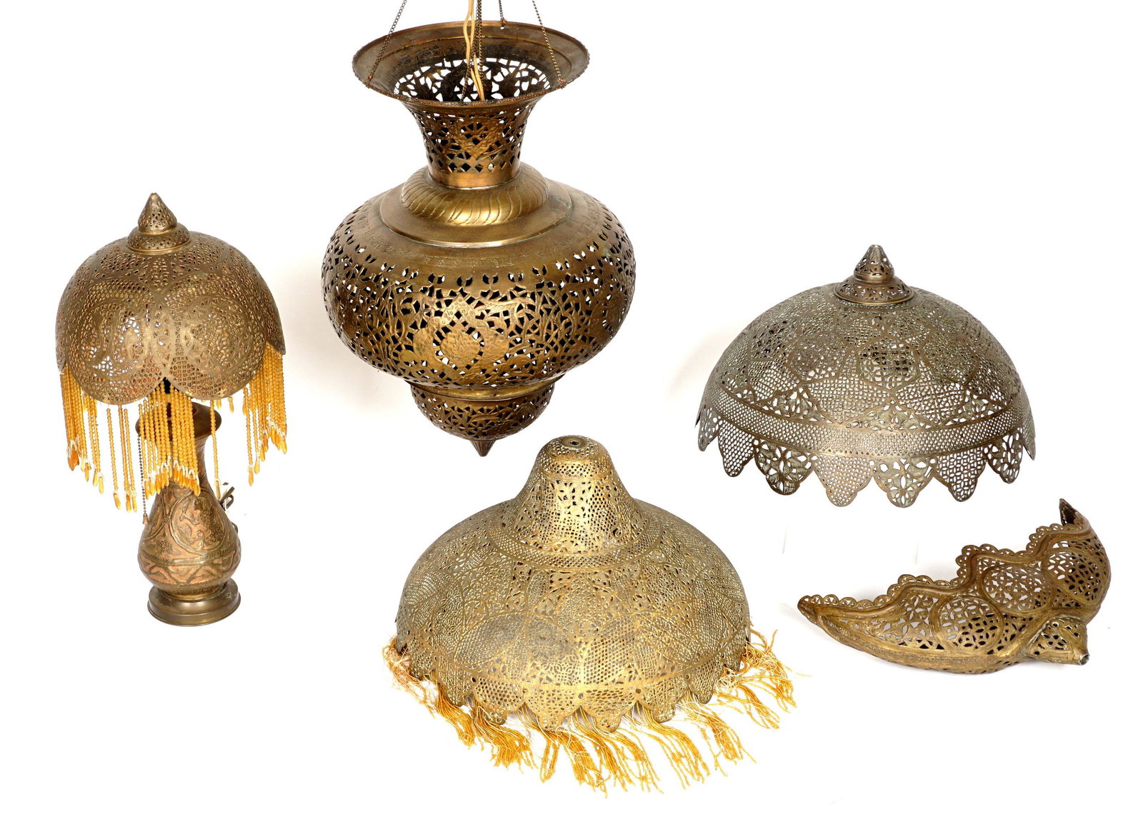 2 Antiques Syrian Pierced Brass Lamps and 3 Shades: Five pieces total to include 1) Table lamp, shade with beaded tassels, 21" x 10.5", missing tassels and beads. 2) Hanging lamp, 28" h. x 15" including chain. 3) Half moon shade, 9.5" x 15.5" x 4.75".