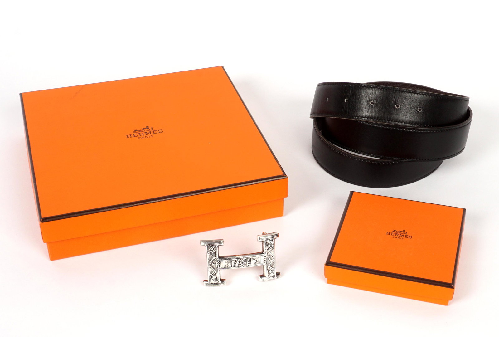 Hermes Touareg Engraved H Buckle & Belt: Hermes hand engraved sterling Touareg "H" buckle with black leather belt. Extremely minor wear to belt. Buckle measures 2.25" x 1.5". Belt 42.75" long. Both well marked. Sold with original boxes. Scuf