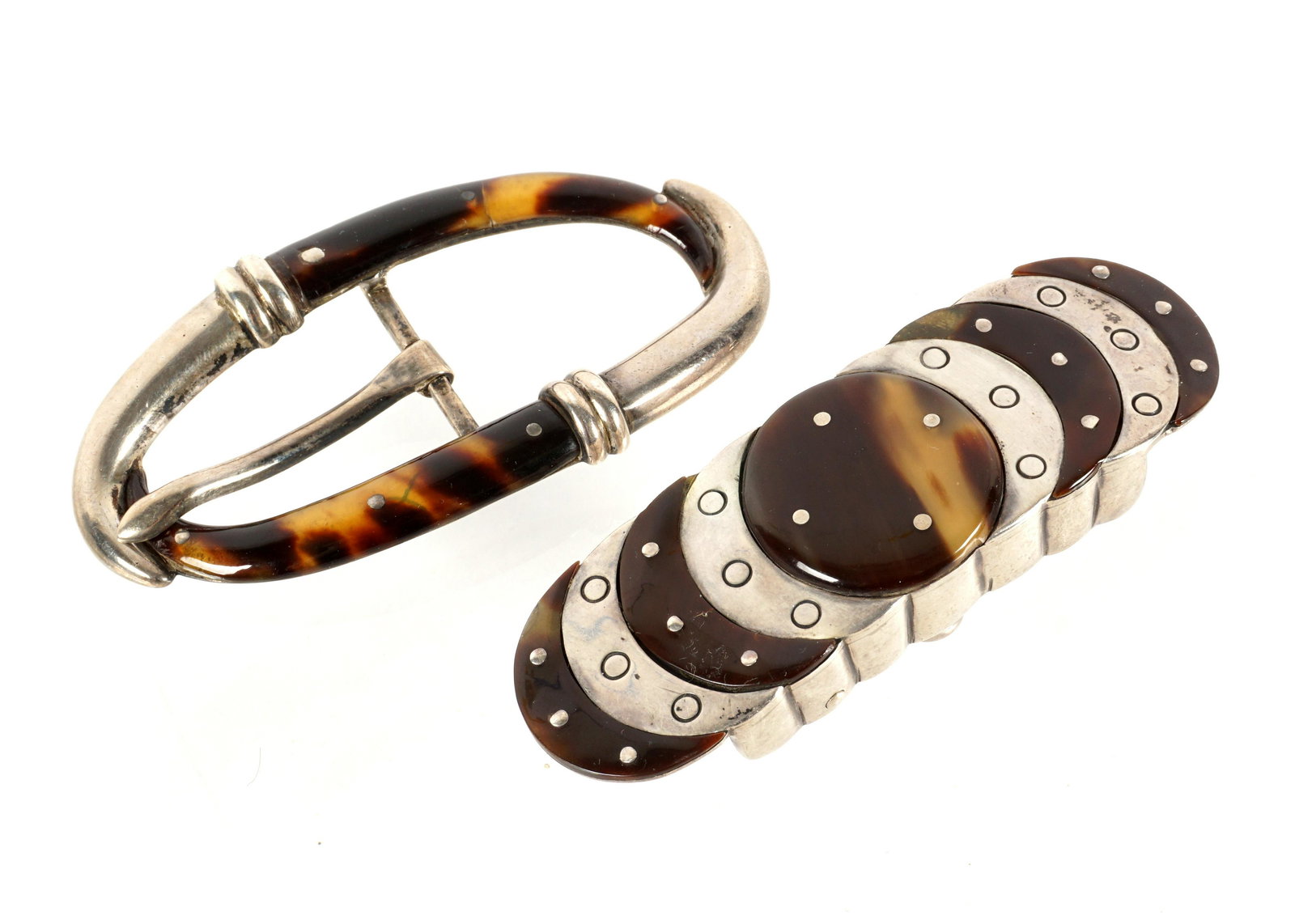 Two William Spratling silver Tortoise Shell Buckle: Two piece total by Mexican silver artist William Spratling, to include 1) Center tortoise shell medallion with radiating bands of silver and tortoise shell, 3.25" x 1". 2) Oval buckle with tortoise sh
