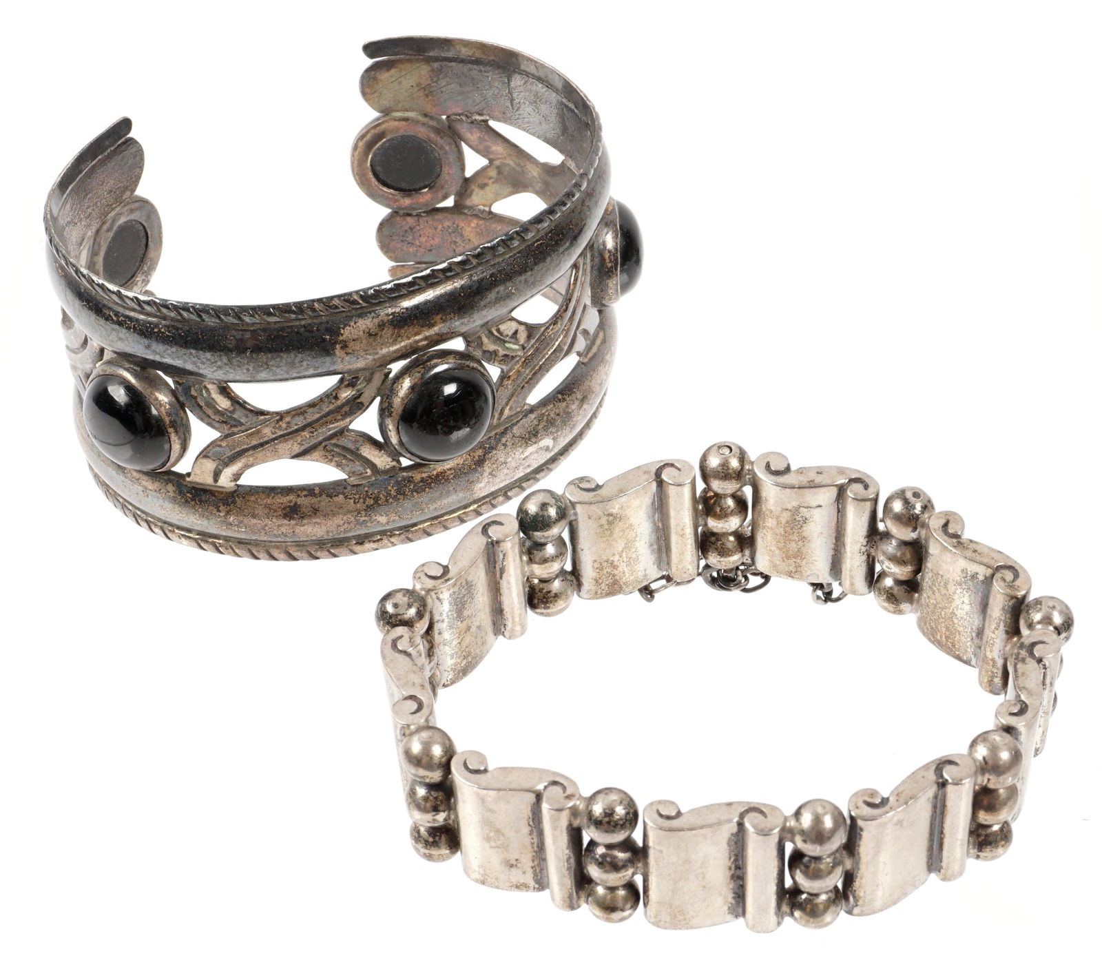 Two Hector Aguilar Mexican Sterling Bracelets: Two pieces total, each from Hector Aguilar, to include 1) Link bracelet with spheres, pin clasp with safety chain, approx. 2" interior dia. 2) Reticulated solid cuff bracelet with inset obsidian caboc