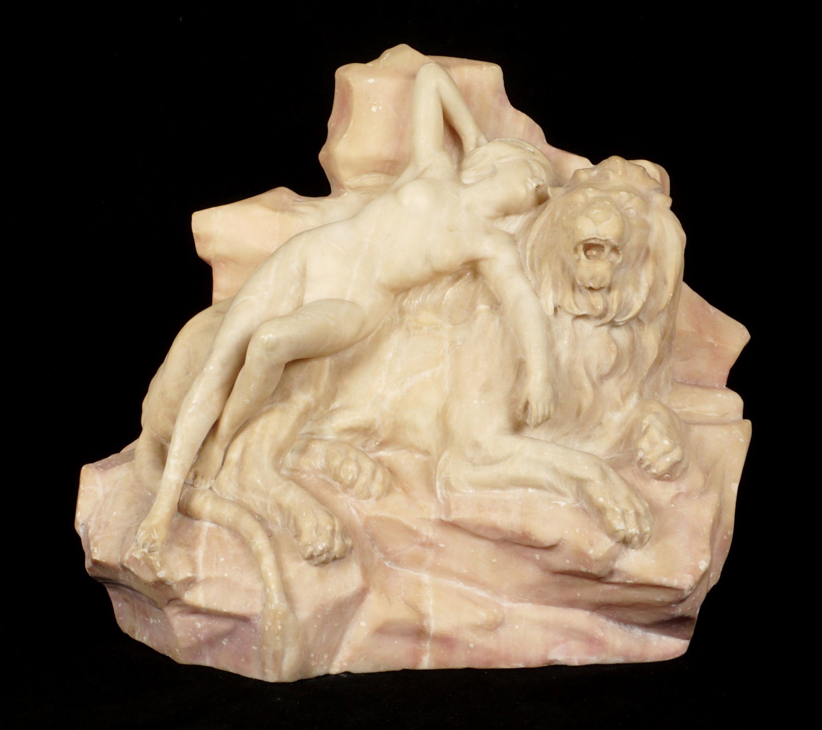 Nude Woman with Lion Carved Marble Sculpture: Carved rose marble, figure of a nude woman lying atop a recumbent lion, unsigned, 12.5" h. x 23.75" x 22.75. Note abrasions to elbow.