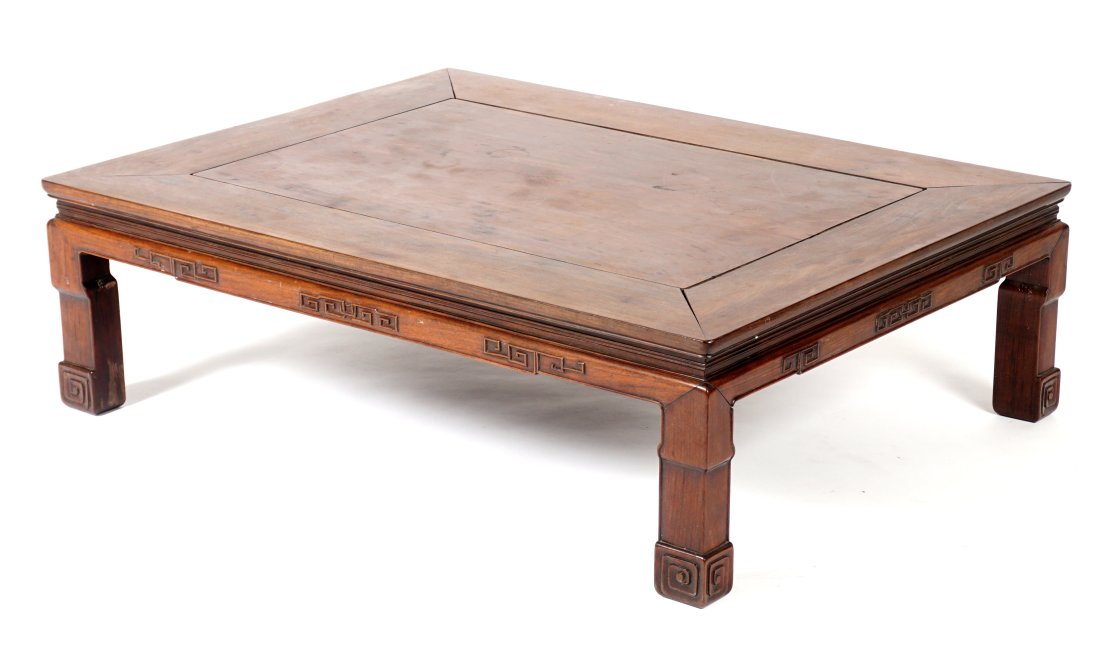 Chinese Carved Rosewood Low Table: Rectangular top over carved and shaped skirt and legs. Overall 14.75" x 47.5" x 35.75". Condition: Wear consistent with age and use.