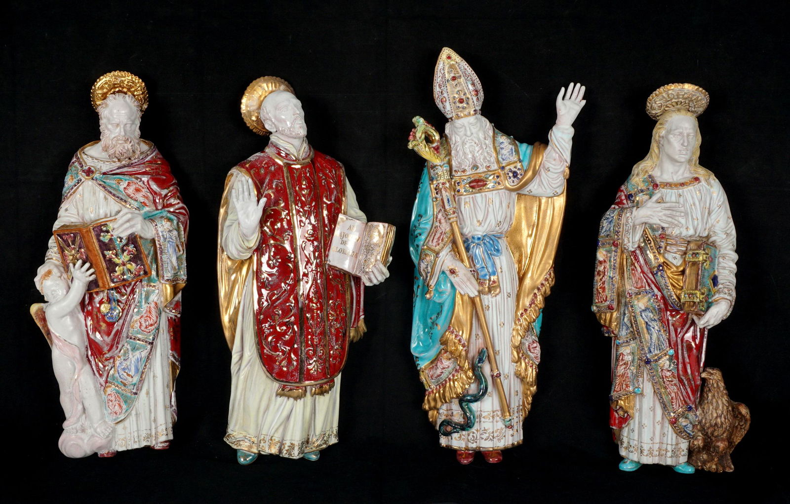 Four Eugenio Pattarino Terracotta Wall Icon Saints: An assembled collection of four Italian polychrome decorated wall icons, each signed Prof. E. Pattarino, Italy, with mold numbers, 16" x 6.5" x 2.25". Condition: One with missing pinky finger and repa