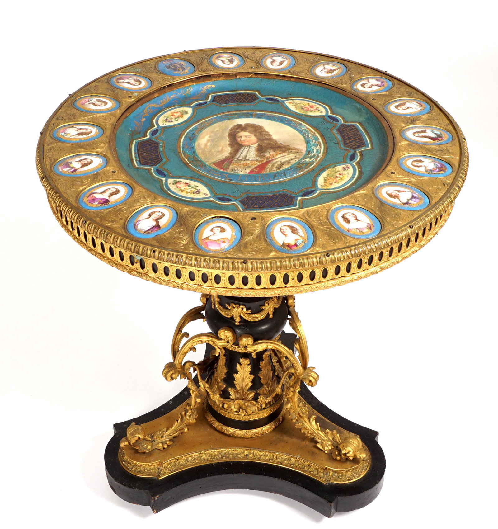 Louis XIV Bronze Dore Giltwood Sevres Plaque Table: Period center table, polychrome decorated round top, center hand painted plaque depicting bust of Louis XIV, border consisting of sixteen plaque bust of women and one with crest, all framed in engrave