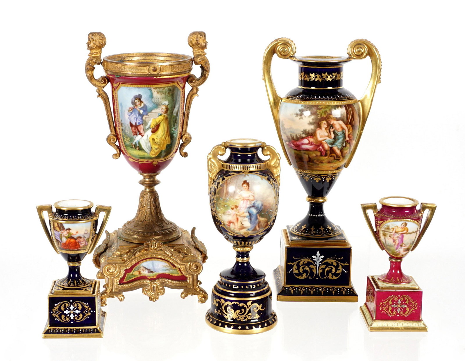 Five Royal Vienna Porcelain Urns: An assembled collection of five pieces total, each with hand painted genre scenes in reserves. Smaller two measure 4.5" h., the largest gilt bronze mounted urn measures 10" h. x 4.5". Largest urn not