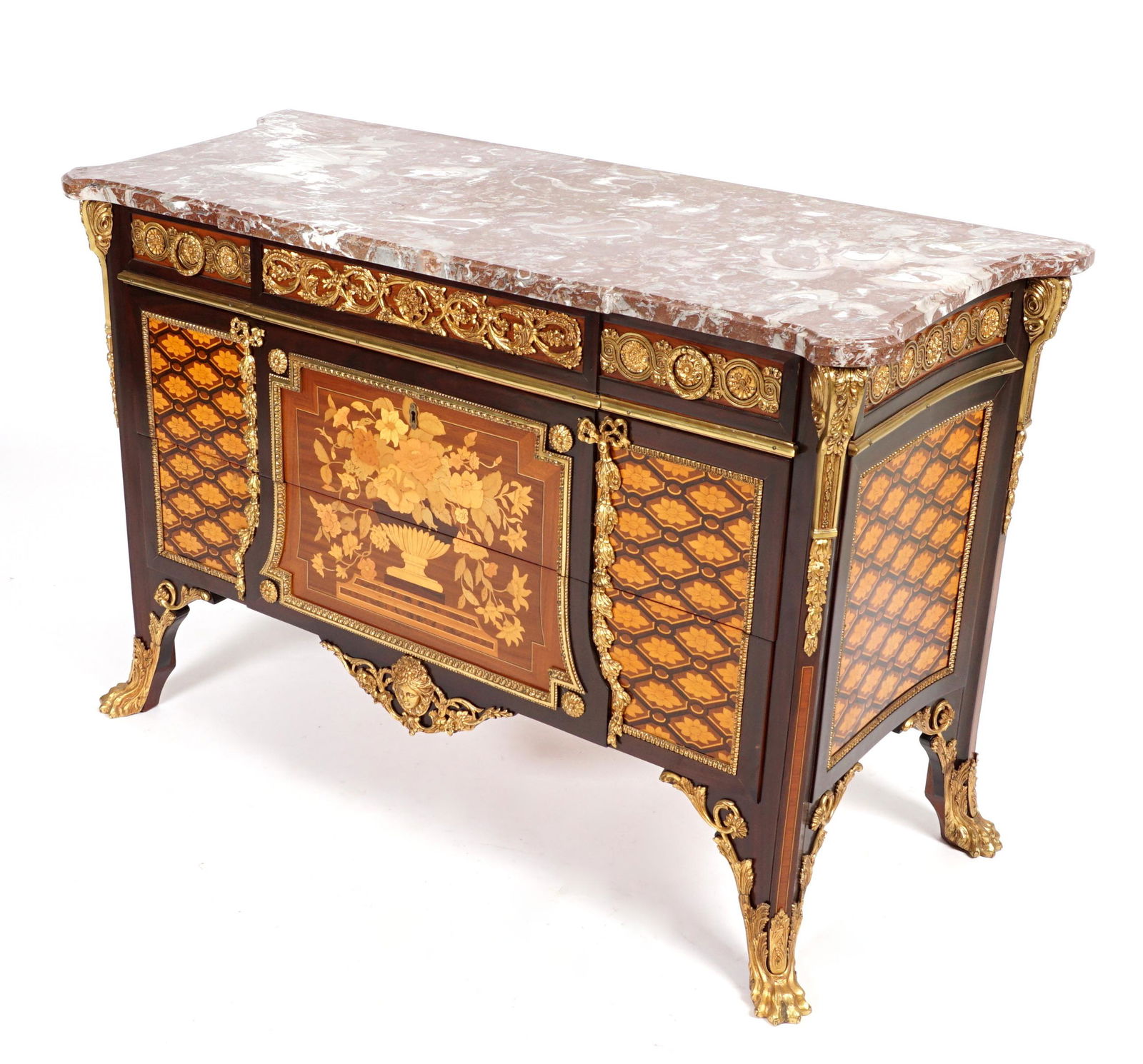 French Ormolu Mounted Parquetry Commode: Sculpted marble top over three drawer case parquetry inlaid panels, applied ormolu mounts and decoration, all on four gilt bronze feet, overall 35" h. x 53.25" x 22.75". Condition: Minor scratches to