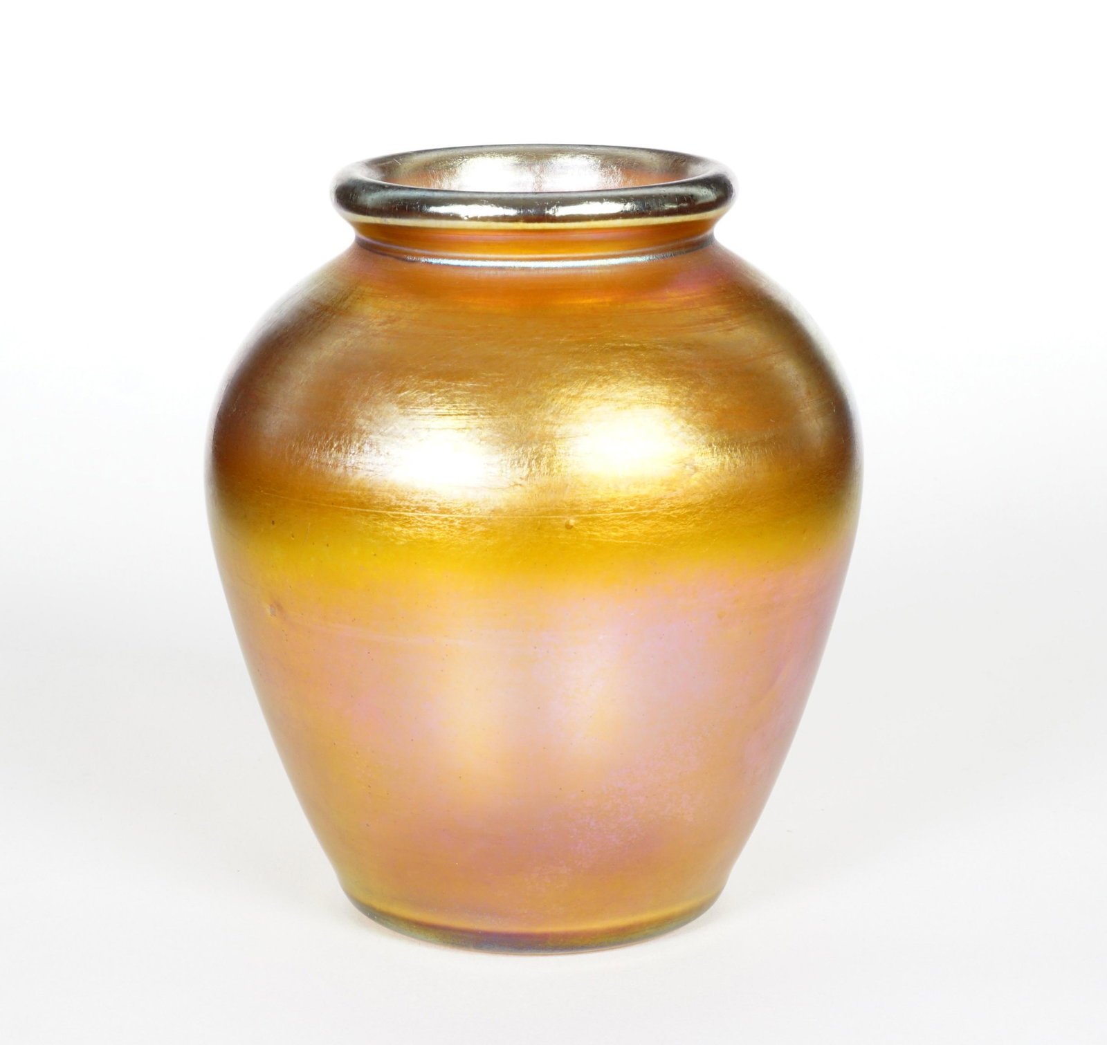 L. C. Tiffany Favrile Vase: Squat form iridescent gold Favrile glass vase, well marked and numbered 1130, 66712. Measures 5.25" h. x 4.5". Condition: Scratches to foot. From the estate of a prominent lawyer from New Rochelle, NY