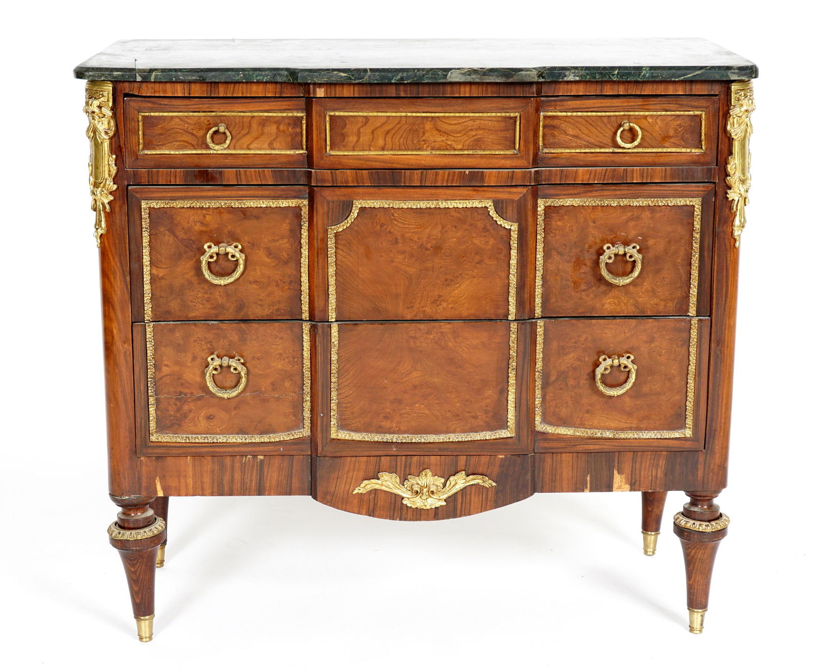 French Marble Top Three Drawer Commode: Shaped marble top over conforming three drawer case, burl wood veneer panels. Gilt metal mounts, decoration and hardware, shaped skirt, all on four tapered legs. Overall 35.5" h. x 38.5" x 17.75". Con
