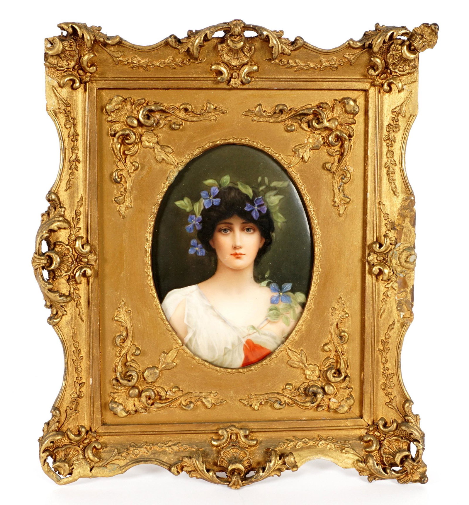 Hutschenreuther Hand Painted Portrait Plaque: Portrait of a beauty with flowers in her hair, signed Wagner, impressed Hutschenreuther mark over 3 verso, 7" x 5", framed 13.5" x 11.25". Condition: Minor scratches near mouth, frame with repairs and