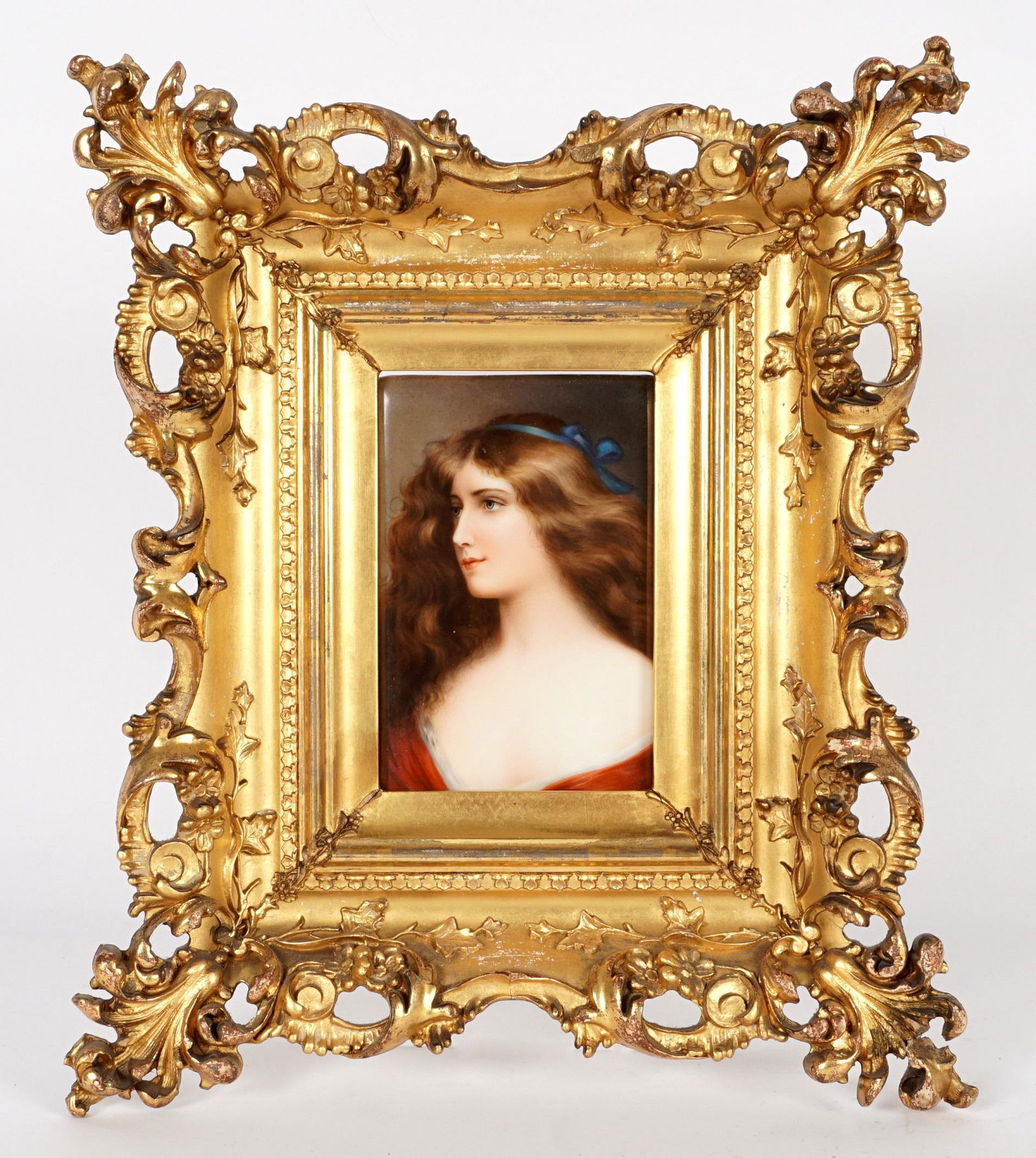 Continental Porcelain Portrait Plaque: Hutschenreuther hand painted portrait plaque of a beauty titled ".Reveuse" verso, impressed makers mark and number 107, 6" x 4". Gilt wood frame 14.25" x 12". condition: Repairs and losses to frame. F