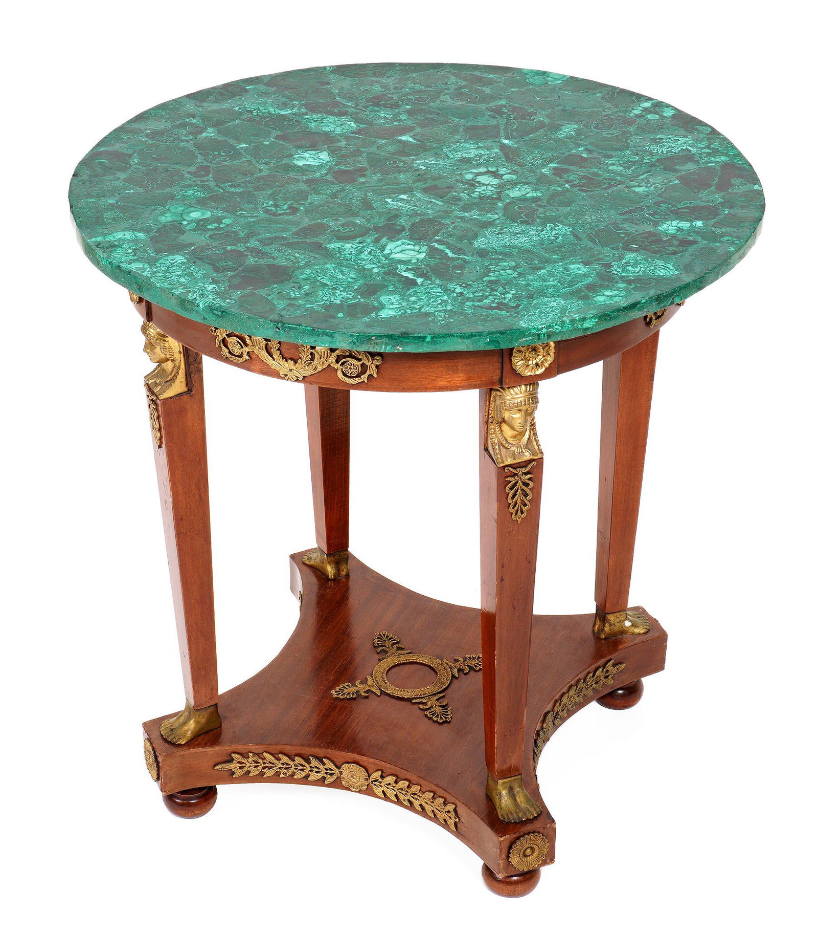 French Empire Style Malachite Top Table: Round malachite veneer top, skirt with applied gilt metal decoration, four tapered supports with gilt metal masks at top, feet at base, splayed base, all on four bun feet. Overall 29.75" h. x 29.5" di