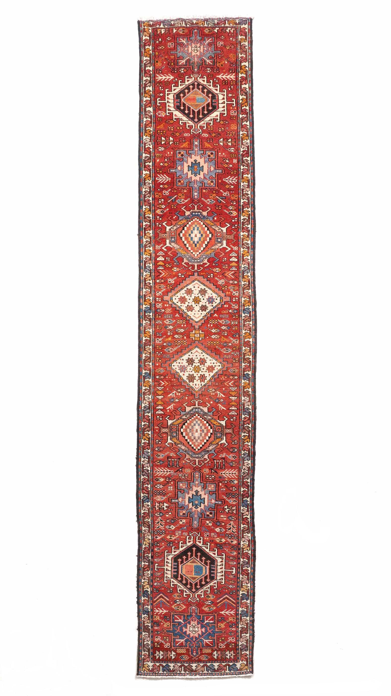 Heriz Persian Runner Rug: Single foliate border band, maroon field with 10 geometric medallions, 2' 4" X 12' 4". Please see photos for condition.