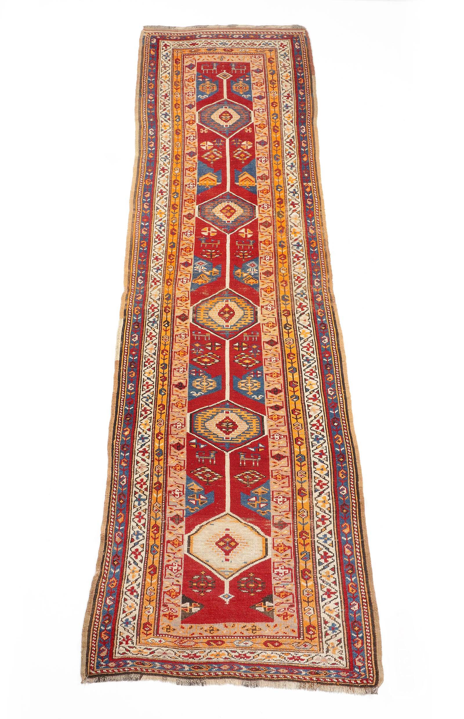 Northwest Persian Runner Rug: Four foliate and geometric border bands, red field ground with stylized animals, five geometric medallions 3' 10" X 12' 9". Mothing, please see photos for condition.