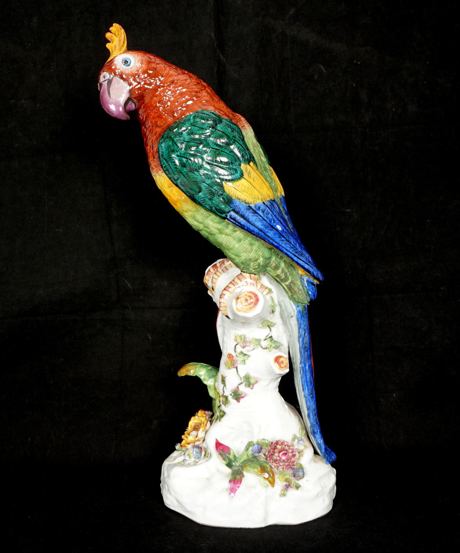 19th C. Continental Porcelain Parrot Figure, Christie's Provenance: Polychrome decorated figure of a parrot on a perch with flowers below, blue crossed lines marking under foot, most likely Limbach, Christie's label underneath, erroneous attribution to Jacob Petit lab