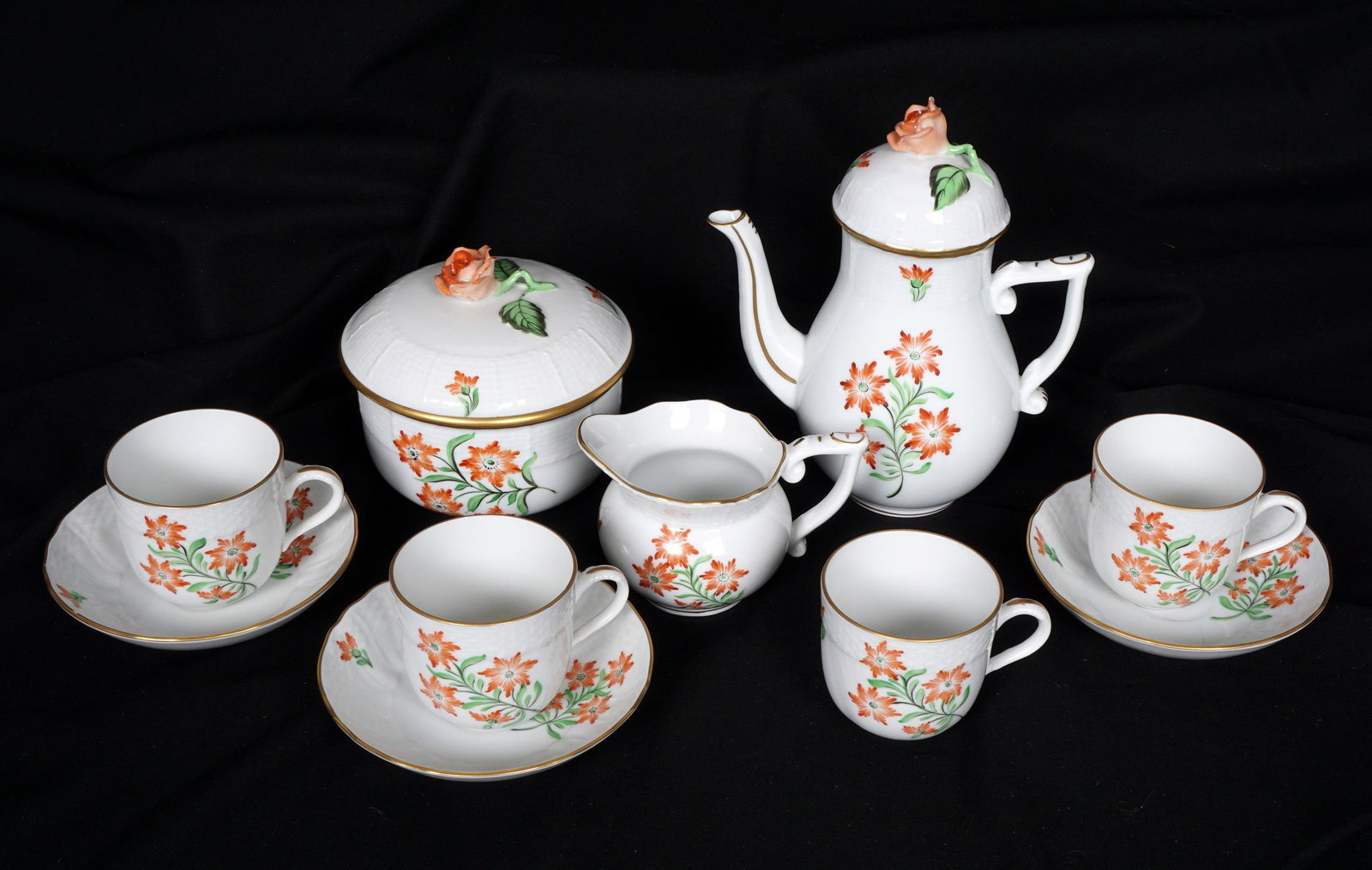 9 Piece Herend Floral Demitasse Set: 9 pieces total in a floral motif by Herend to include demitasse pot with lid (6.5" h., chips to finial), covered sugar (3.75" h. x 4.5), open creamer, (4.25" dia.), 4 cups (2.25" h.), 3 saucers (4.5"