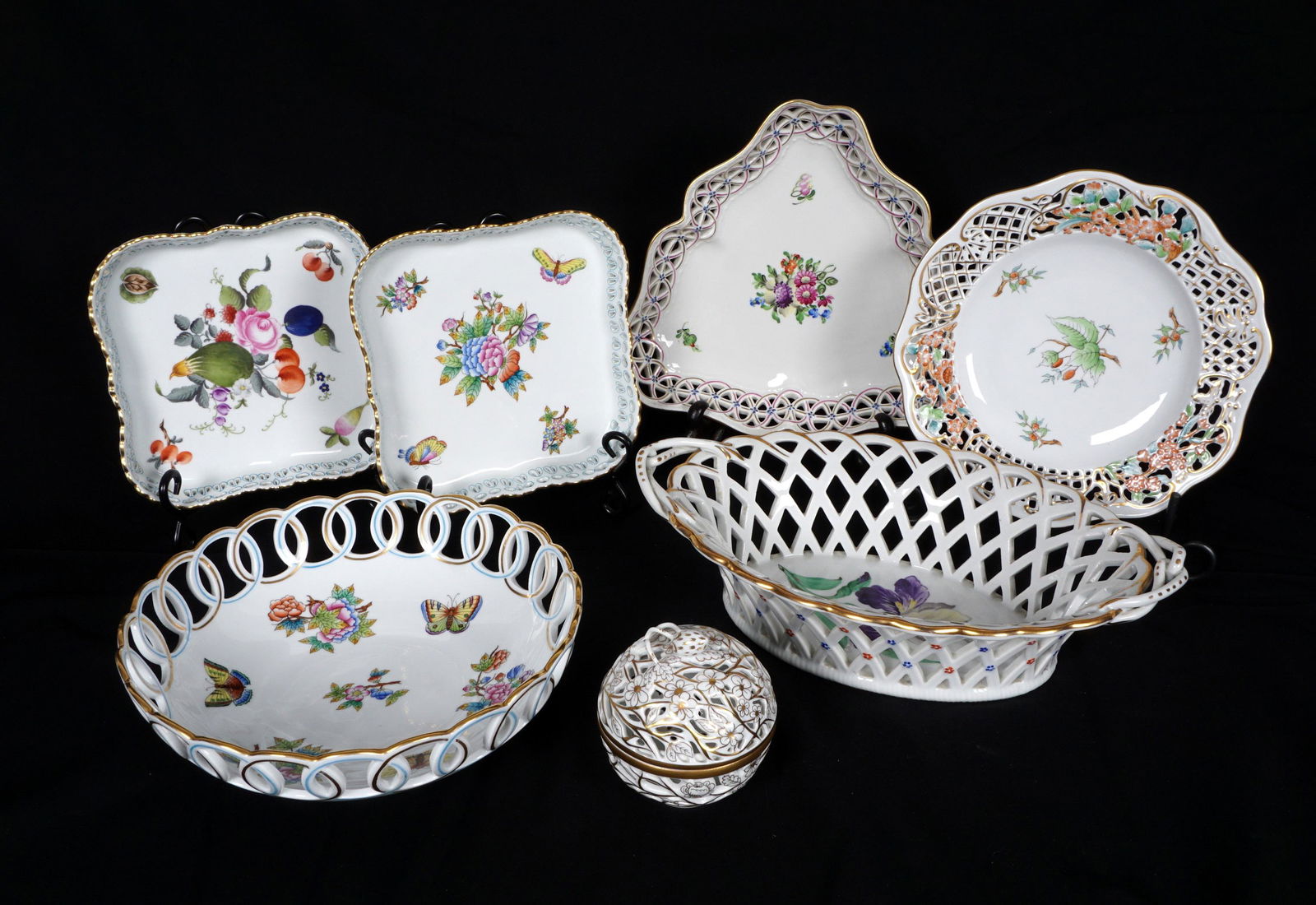 7 Piece Herend Reticulated Trays & Covered Bowl: Seven pieces in assorted patterns total to include round bowl (3" x 9.5"), triangular dish (9.75"), oval basket (3" h. x 12.5" x 8.5"), plate (9.25"), two square trays (7.25" x 7.25"), covered bowl (3