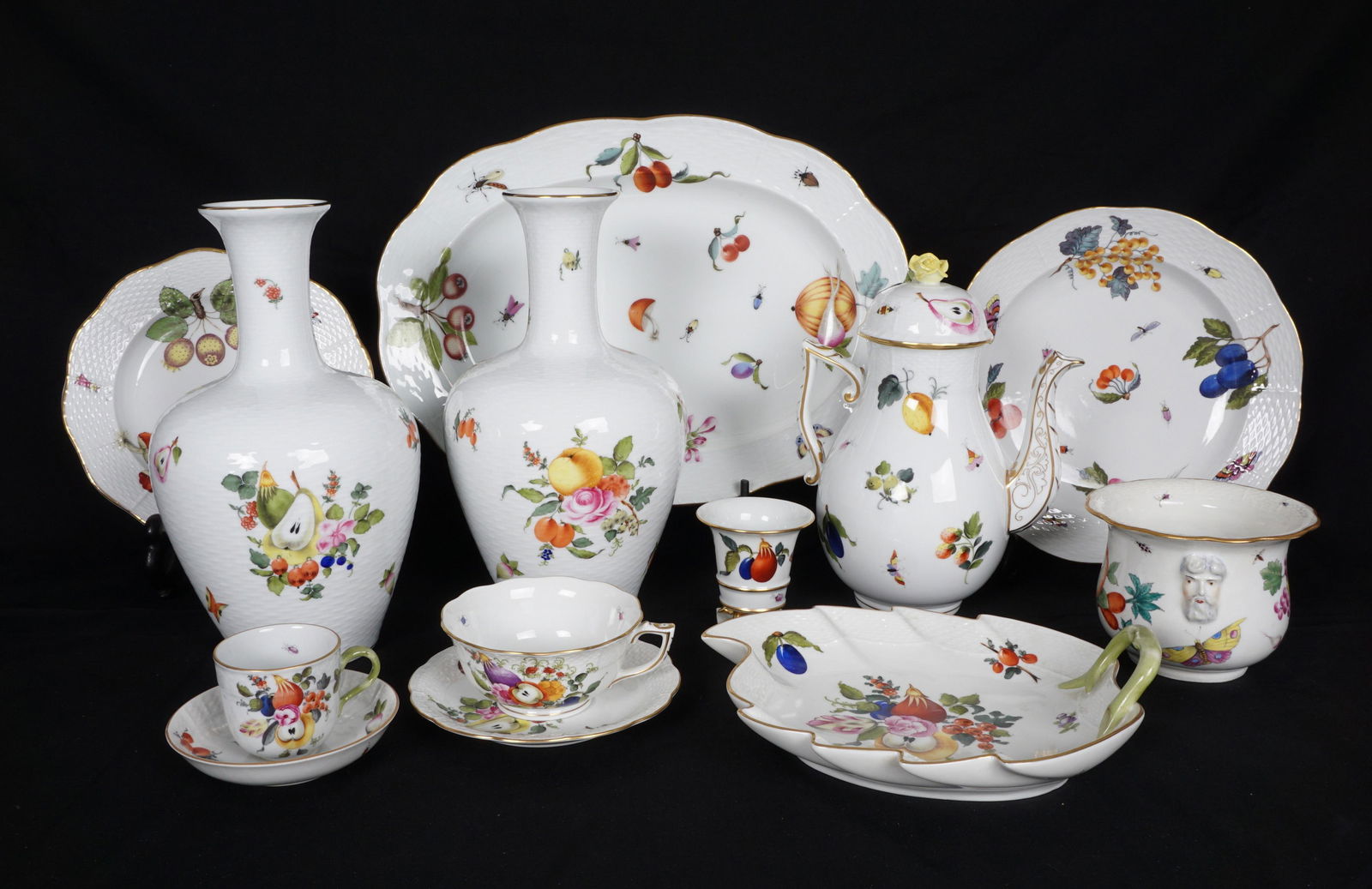 13 Piece Herend Fruits and Flowers Tableware: An assembled collection of 13 pieces total in the Fruits and Flowers pattern by Herend to include 1) Coffee pot with rose finial, (9"). 2-3) Pair of vases (10.5" h.), 4) Cache pot (3.75", restoration