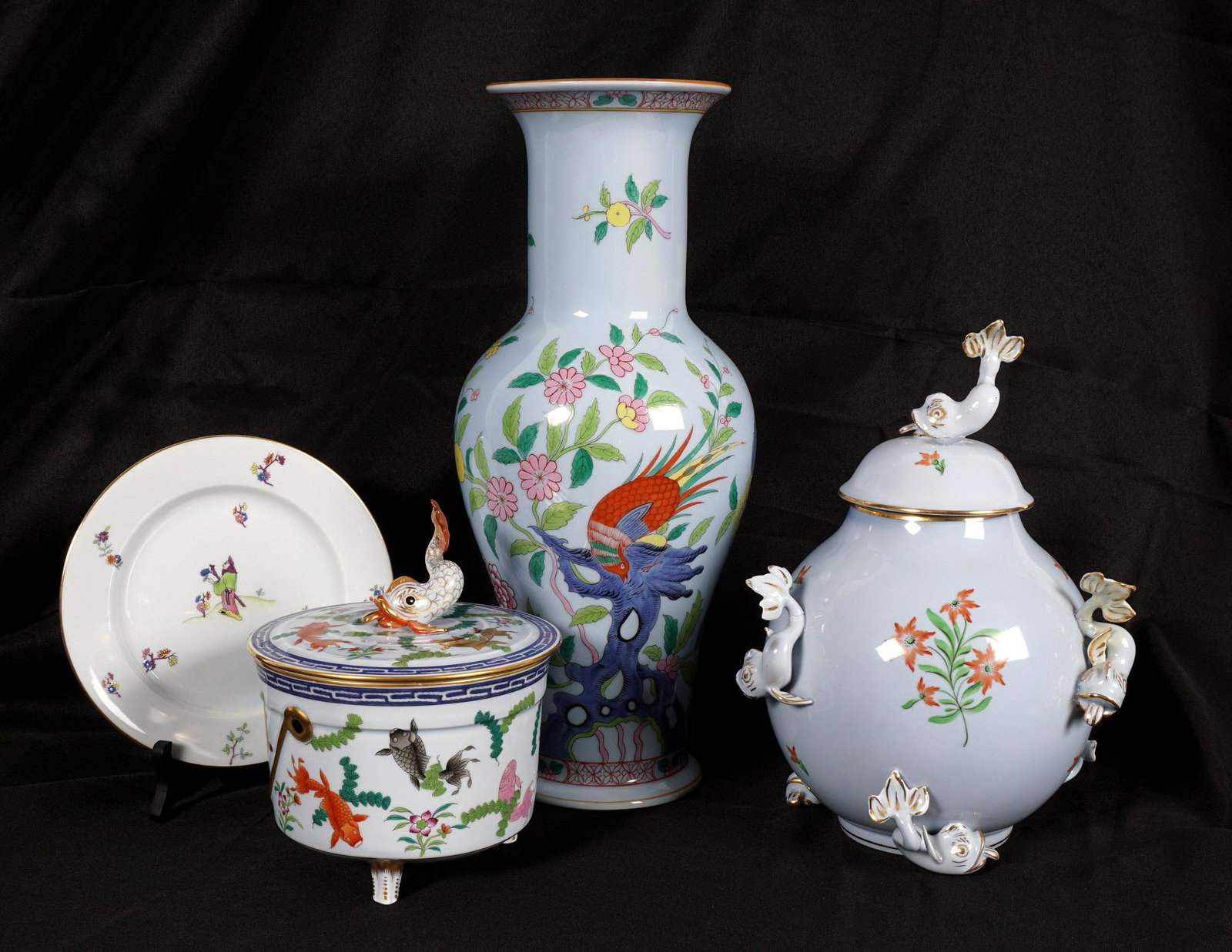 4 Piece Herend Blue Ground Tableware Items: An assembled collection of four pieces total in assorted patterns by Herend to include 1) Covered jar with applied dolphin finial and decoration, 10.5" h. x 8",. Note repairs to two dolphin tails. 2)