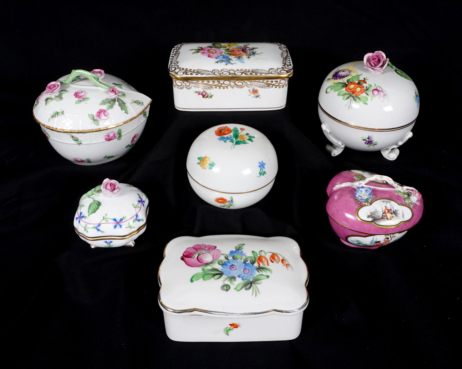 7 Piece Herend Covered Boxes: An assembled collection of seven pieces total by Herend, largest leaf form box with branch handle measures 4.25 "h. x 5.25", smallest 2.5" h. x 2.75". From the estate of European collector Mark Melamu