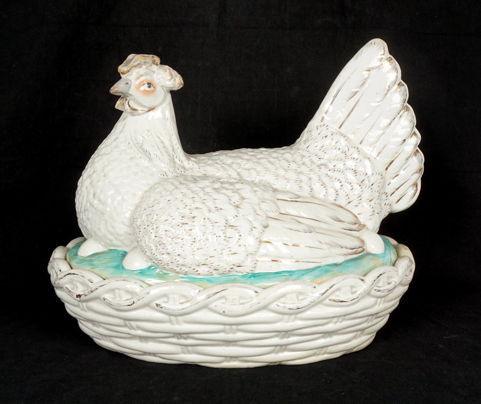 Large Staffordshire Hen on Nest: White with gilt accents, polychrome eyes and nest, unmarked, 12.25" h. x 15.5" x 11.25". Condition: Rim chips and wear to decoration.