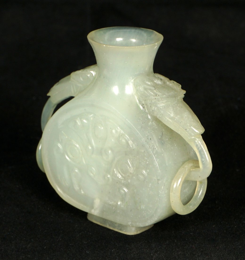 Antique Diminutive Chinese Mutton Fat Jade Vessel: Mutton fat jade or similar stone, miniature jade double handle vessel, carved floral decoration. Overall 2.25" h. x 2.75". Condition: Fleabites to rim.
