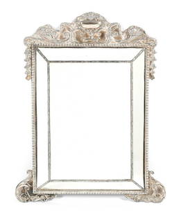 English Sterling Cushion Frame Dressing Mirror: Embossed sterling silver clad frame featuring center urn with fruit, cornucopia, foliate scroll, and bellflowers. Hallmarked William Comyns, 1864, London. Large center mirror with four canted side