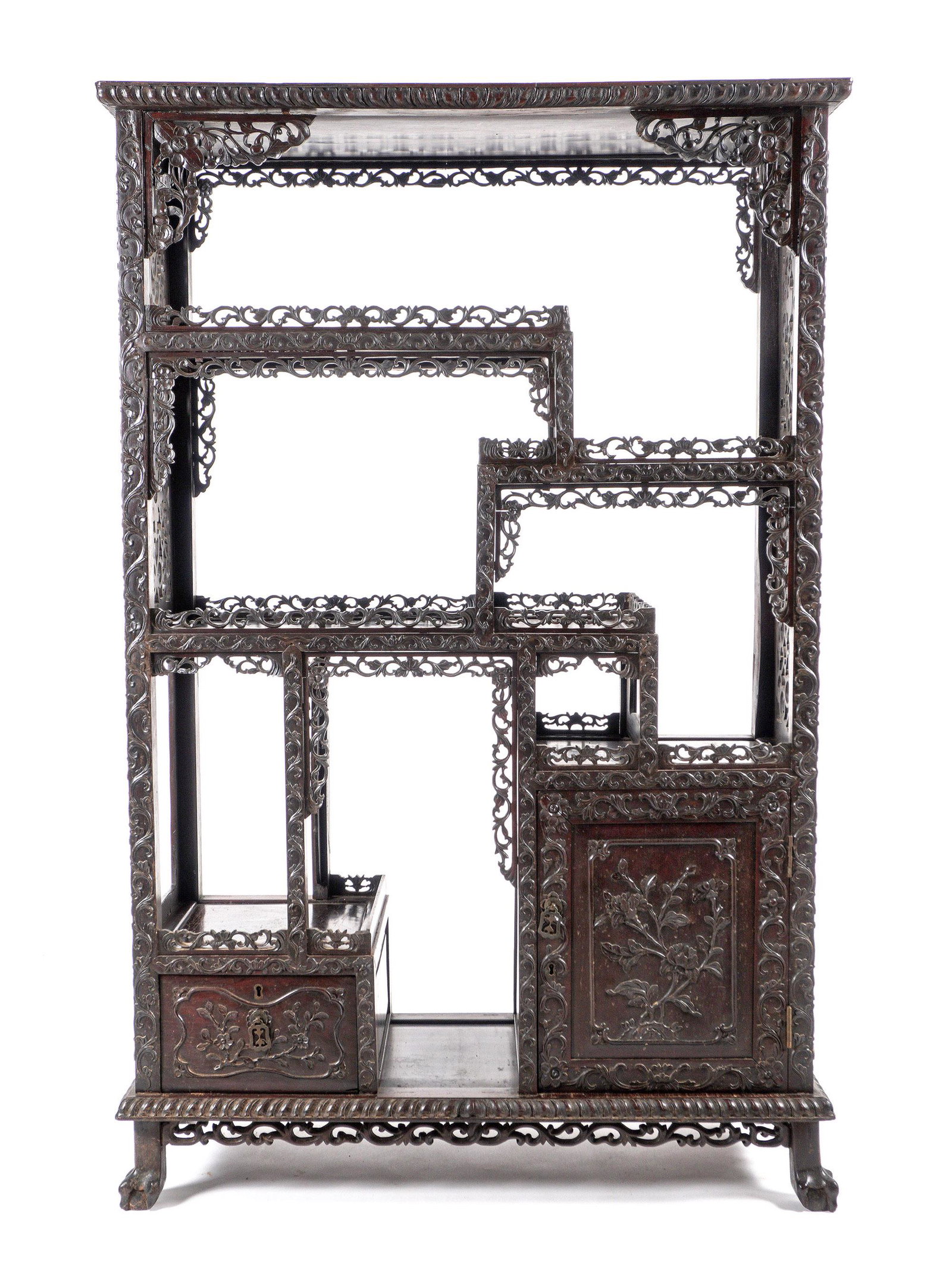 Chinese Carved Hardwood Etagere: Multi level open shelves, reticulated pierced carved galleries and side panels, carved single door and drawer fronts, all on four claw feet. Overall 65.5" h. x 42.5" x 16.75". Condition: Repair to one