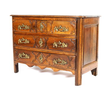 18th Century French Walnut Commode: Rectangular top with rounded front corners, three drawers over two drawers carved drawer fronts, cast metal pulls, shaped skirt, on four feet. Overall 33.5' h. x 46.5" x 22.5". From the estate of Haze