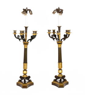 Pair French Bronze Candelabra Lamps: Patinated and gilt bronze lamps, five scroll candle arms, top center three light electric fixture, splayed base, unmarked, overall 35.75" h. x 11.75". Condition: Several arms slightly askew.