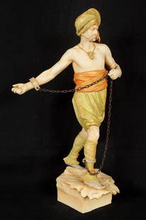 Amphora Pottery Figure of a Shackled Man: Figure of a shackled slave or prisoner, polychrome decorated, impressed Amphora, 4427, 22, RSTK stamp, overall 24.5" h. x 14.5" x 10.5". Condition: Right arm and thumb reattached, crazing. From the es