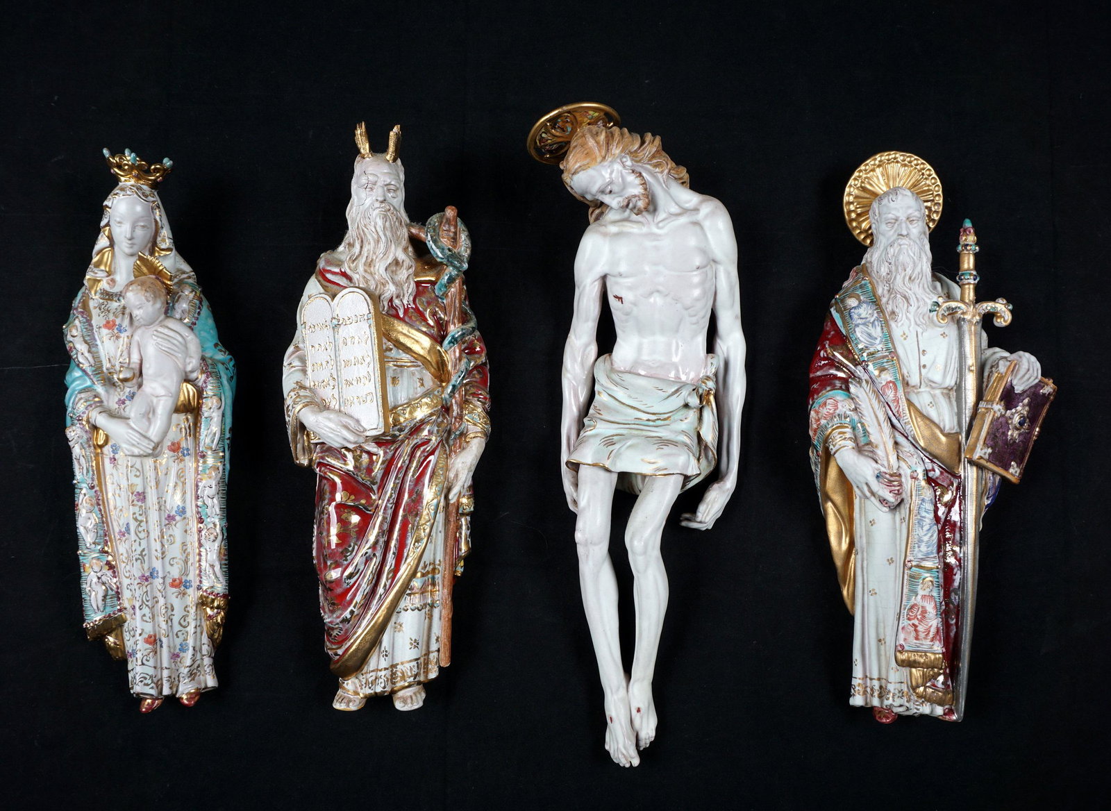 Four Eugenio Pattarino Terracotta Wall Icons: An assembled collection of four Italian polychrome decorated wall icons, two saints, Mother and Child, and Jesus each signed Prof. E. Pattarino, Italy, with mold numbers, 14.5" x 4.75" x 2". Condition