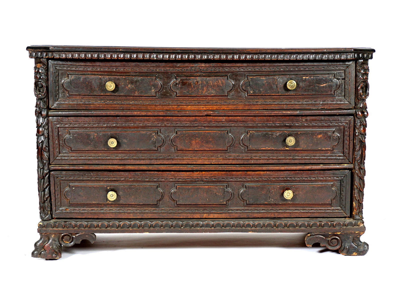 Antique17th Century Walnut Italian Carved Chest: Rectangular top with canted corners, conforming case with three drawers, raised panels on drawer fronts. Carved canted corners with masks, retains original backboards and feet, ancient surface. Overal