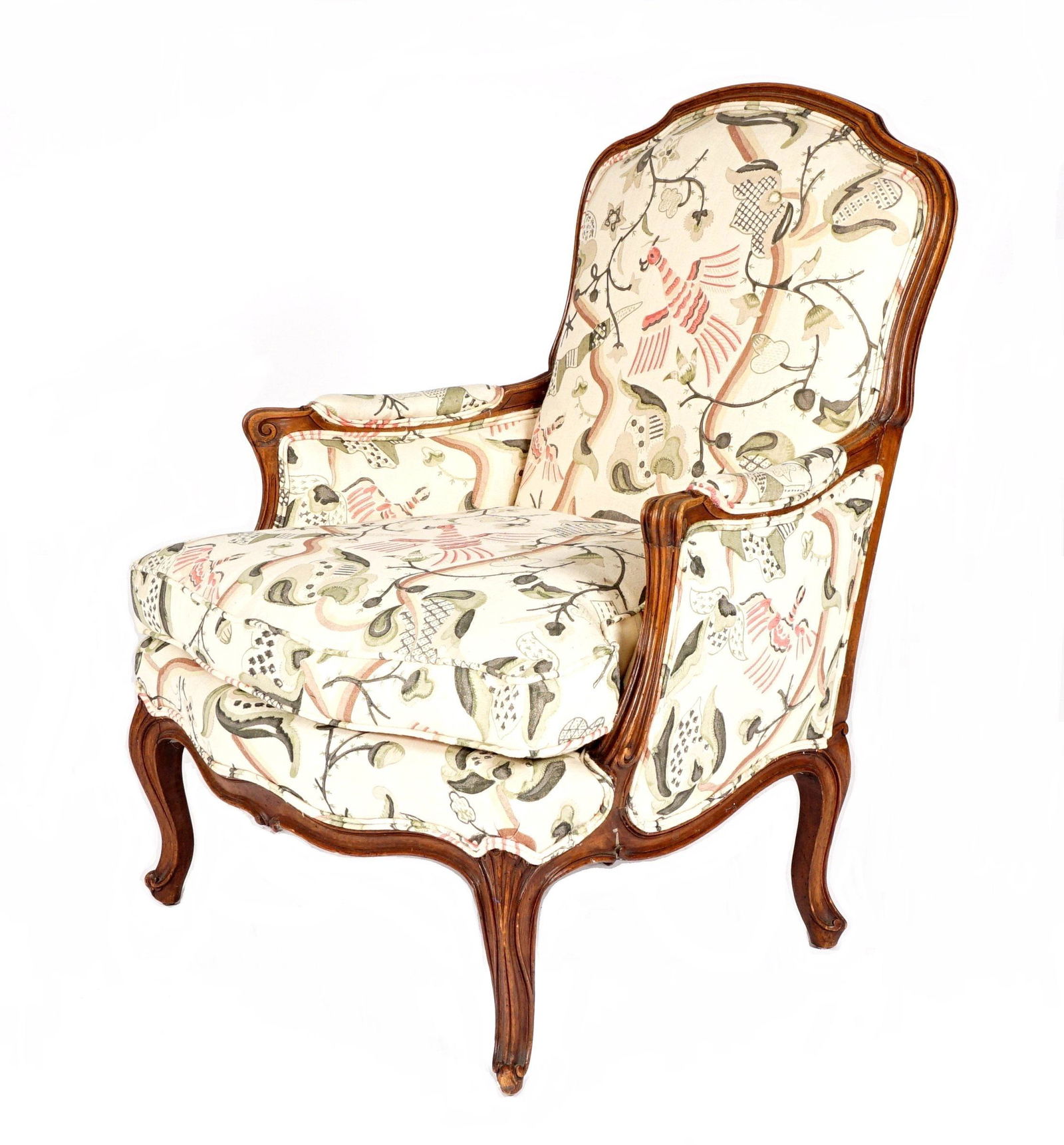 French Walnut Bergere Arm Chair: Carved fluted walnut frame, scroll hand holds, cabriole legs, bird and branches patterned upholstery, 39" h. x 29.5" x 30.5". From the estate of Hazel Hanlon, lifetime collector and fine antiques deal