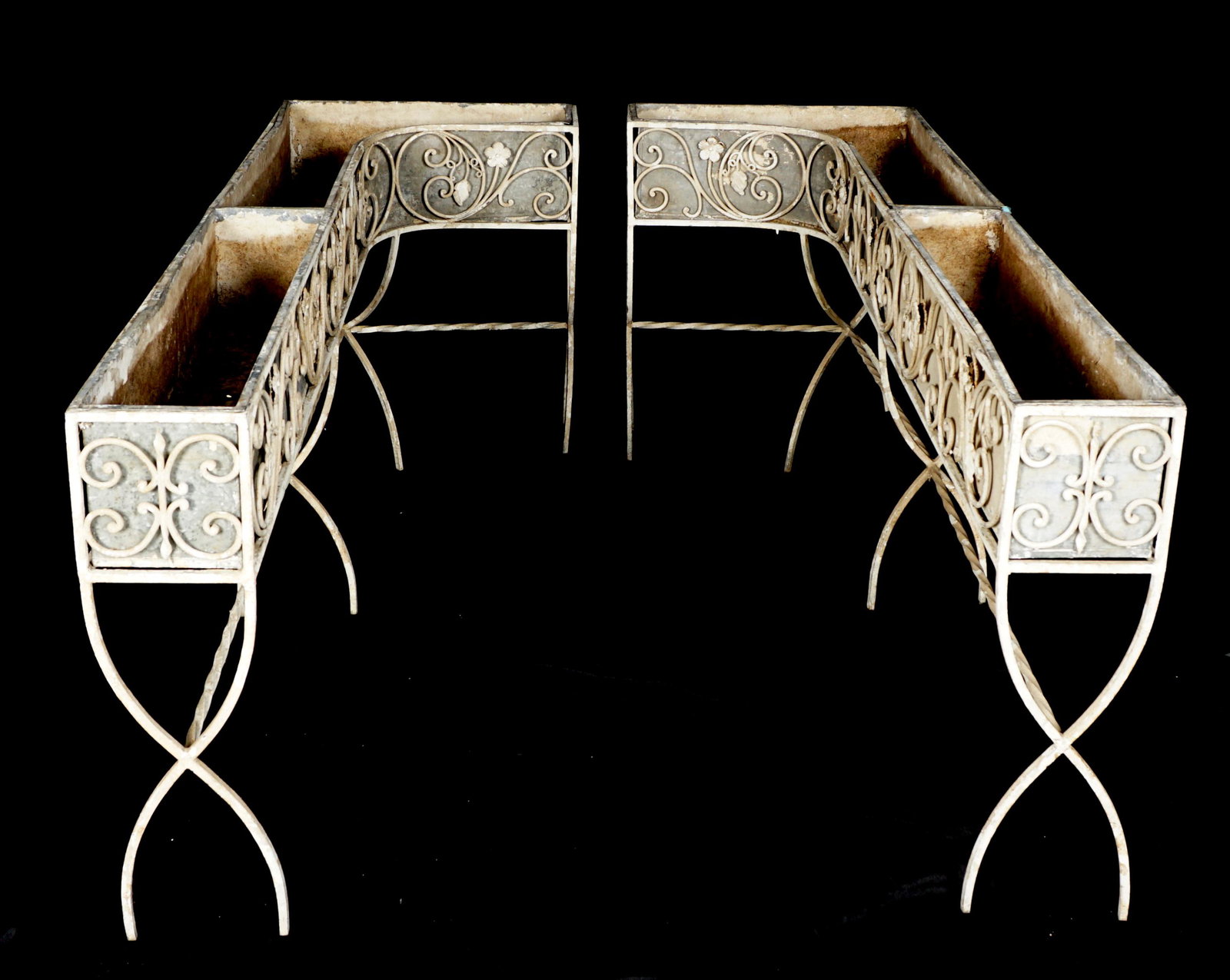 Pair L Shaped Wrought Iron Outdoor Planters: Early 20th Century, wrought iron "L" shaped stands with tin inserts, overall 28.5" h. x 69" x 24", Condition: Obvious wear and weathering, one leg repaired.