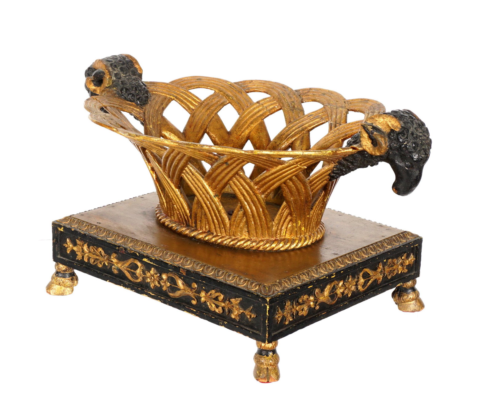 French Carved Gilt Wood Rams Head Centerpiece: Carved gilt wood reticulated basket with ebonized head handles, carved base with foliate scroll decoration, on four hoof feet, 8.5" h. x 16.5" x 10.5". From the estate of Hazel Hanlon, lifetime collec