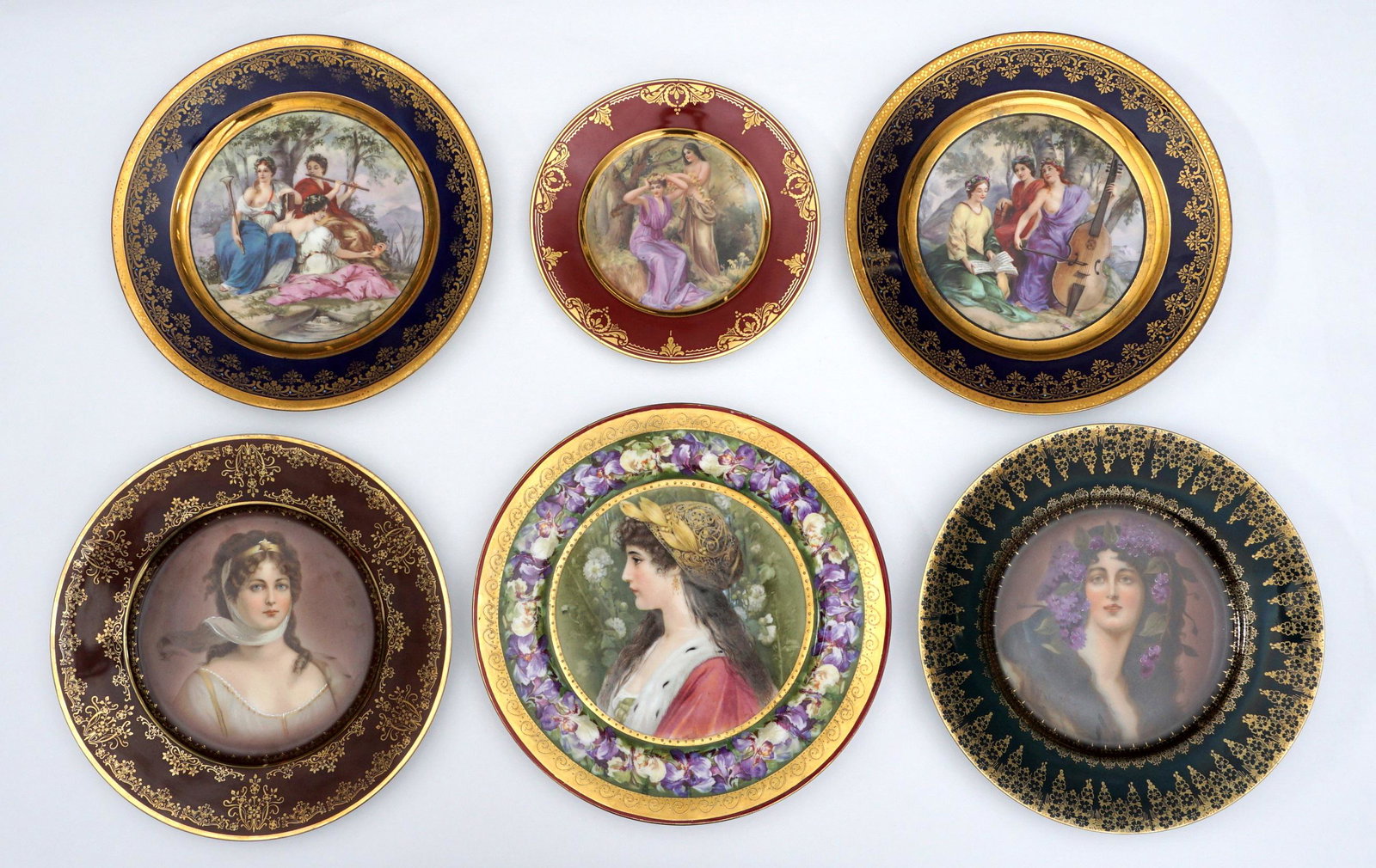 Collection of Six RoyalVienna and Style Plates: An assembled collection of six portrait plates, four bearing Royal Vienna markings to include Queen Louise, Terrier, 2 depicting the three muses. Imperial Crown China portrait of a woman, and two beau