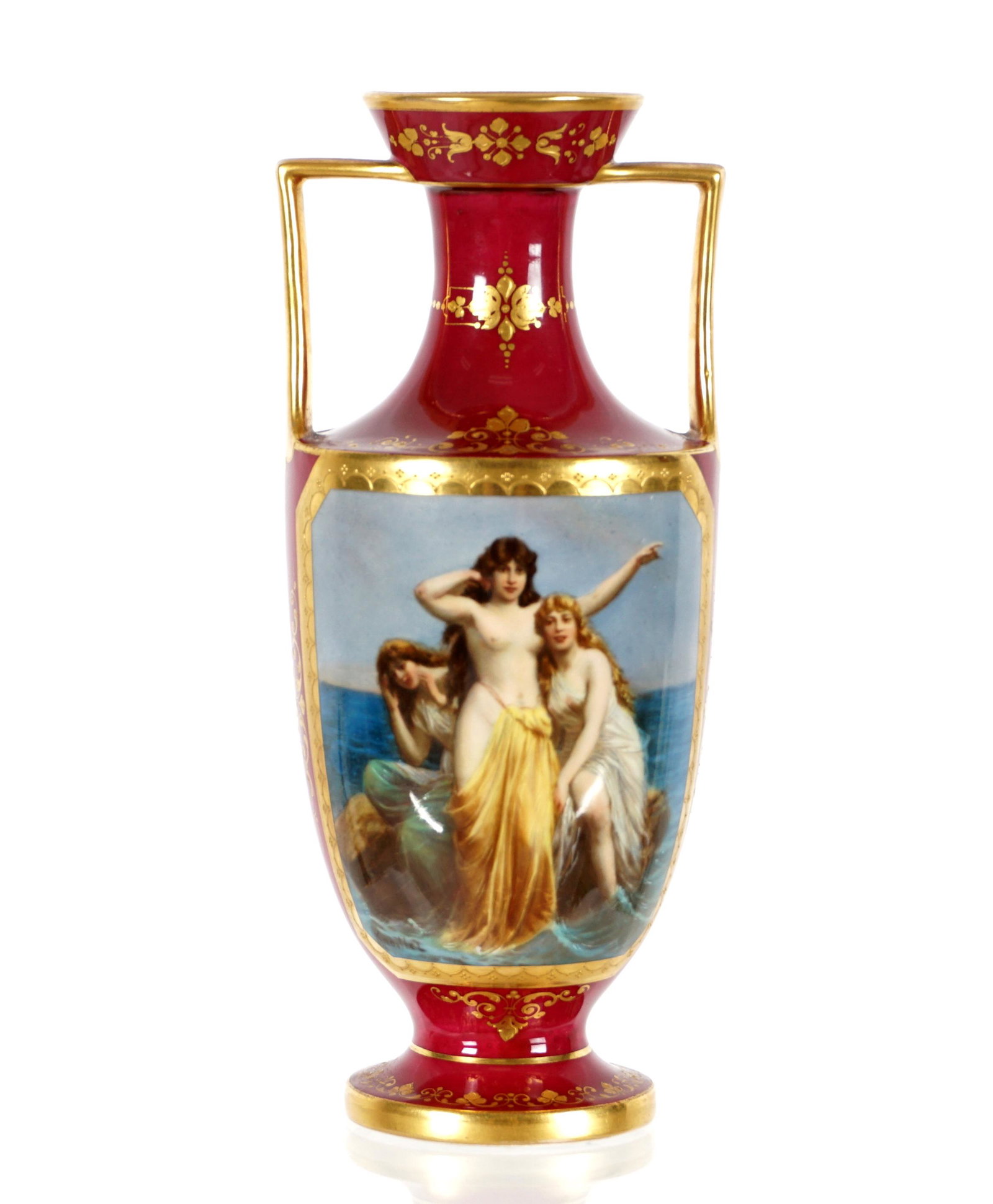 Royal Vienna Knoillez Three Graces Handled Vase: Maroon ground with gilt accents, depiction of three semi nude maidens in reserve signed Knoillez, Royal Vienna mark on base, overall 7.25" h. x 3.25". From the estate of a prominent lawyer from New Ro