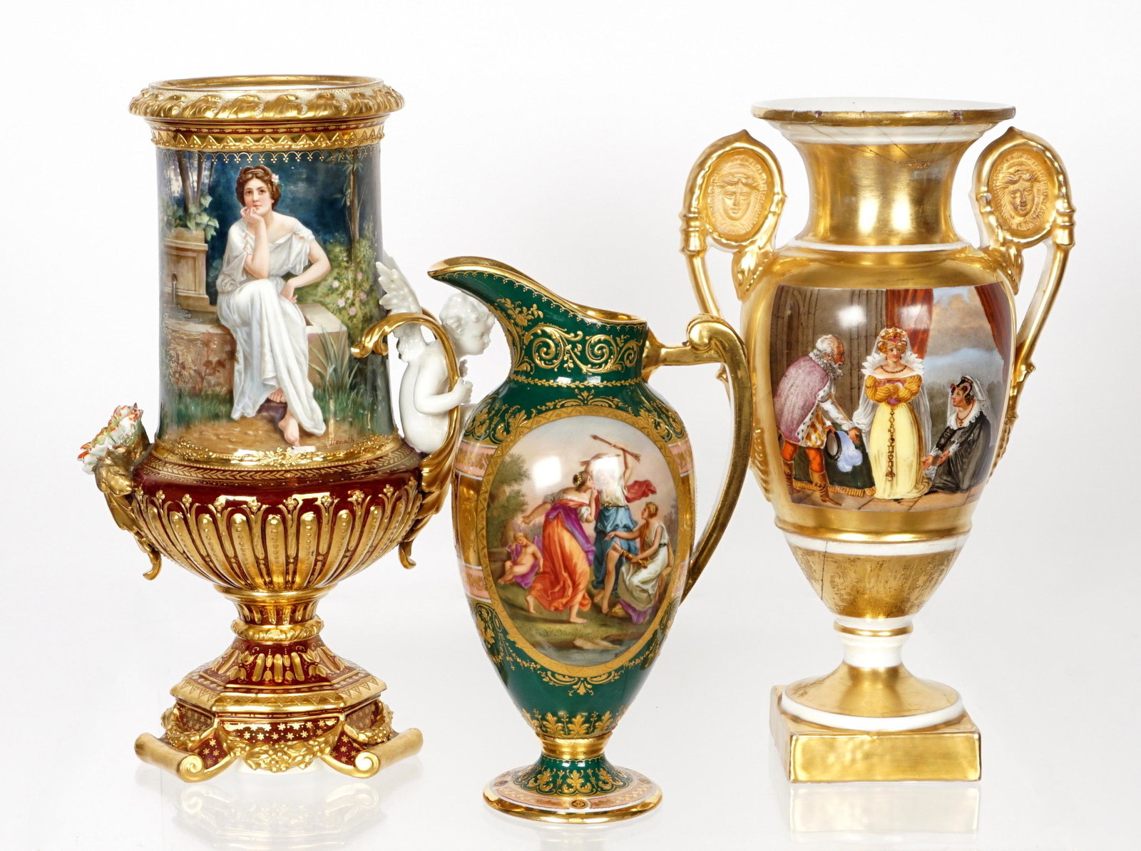 Three Royal Vienna Porcelain Urns: An assembled collection of three pieces total, to include 1) Royal Vienna "Waldesschweigen" urn, portrait of a woman, applied flower, figural cherub at handle, well marked on base, 10.75" h. x 7". Not