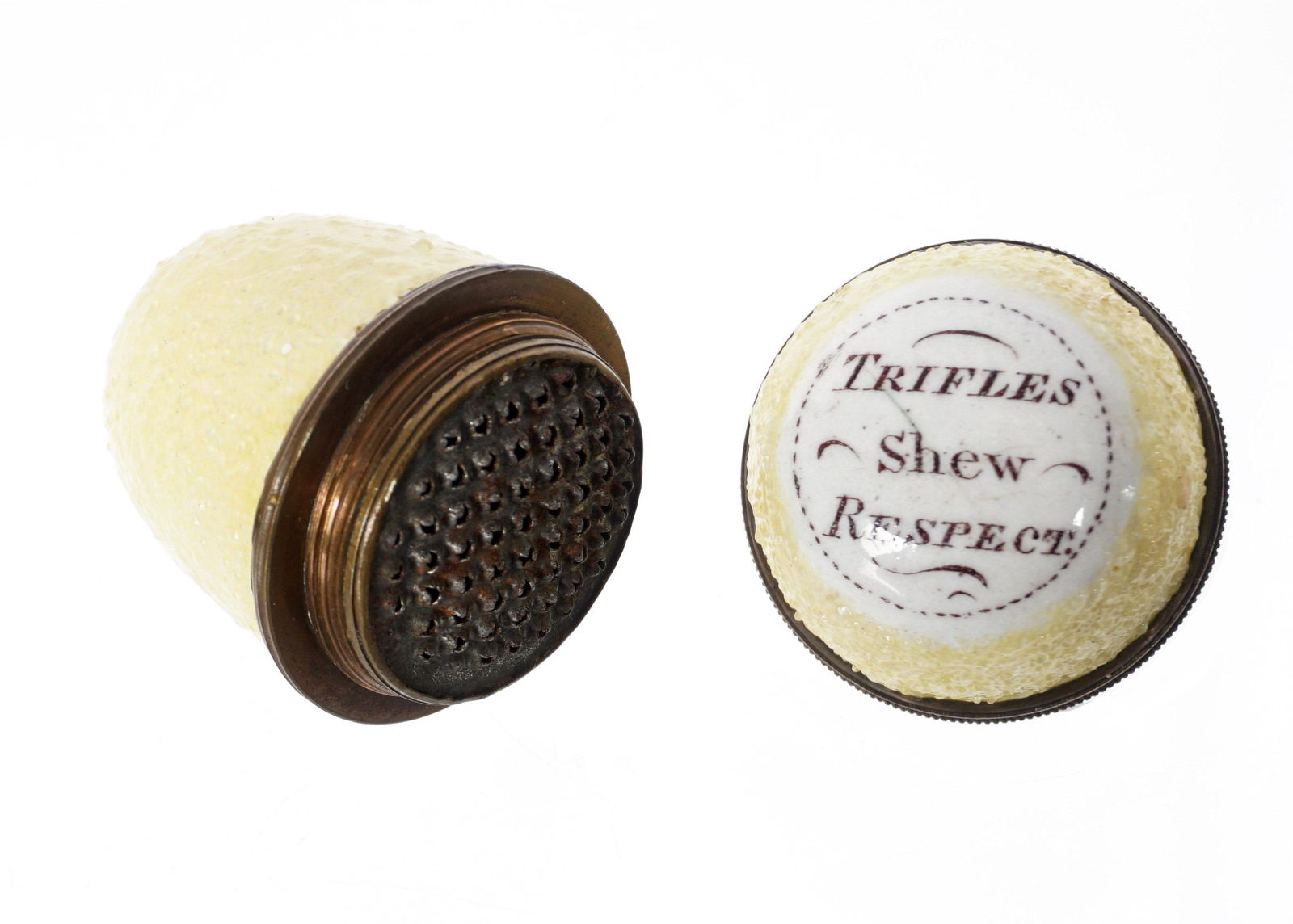 Antique Bilston Yellow Egg Nutmeg Grater Trifles Shew Respect: Yellow sugar ground egg shaped nutmeg grater, top legend reads "Trifles Shew Respect", top unscrews to reveal grater, 1.75" h., sold with acrylic stand .75" h.