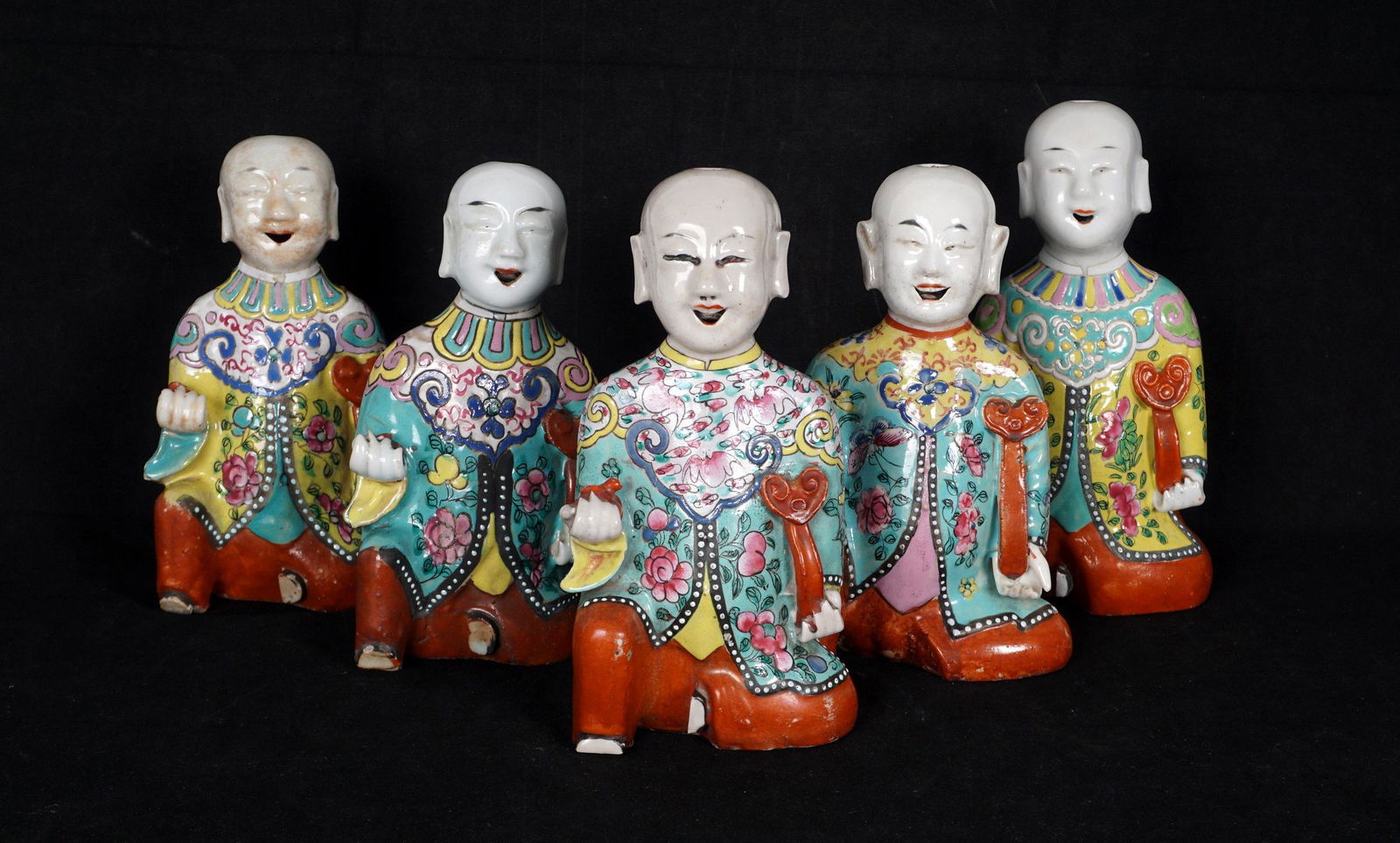 Five Chinese Porcelain Figural Incense Burners: A collection of five similar, but not identical, figures of seated Chinese figures holding a ruyi scepter, tallest measures 7.75" h. x 4" x 2.75". Condition: Minor wear to decoration, one missing fing