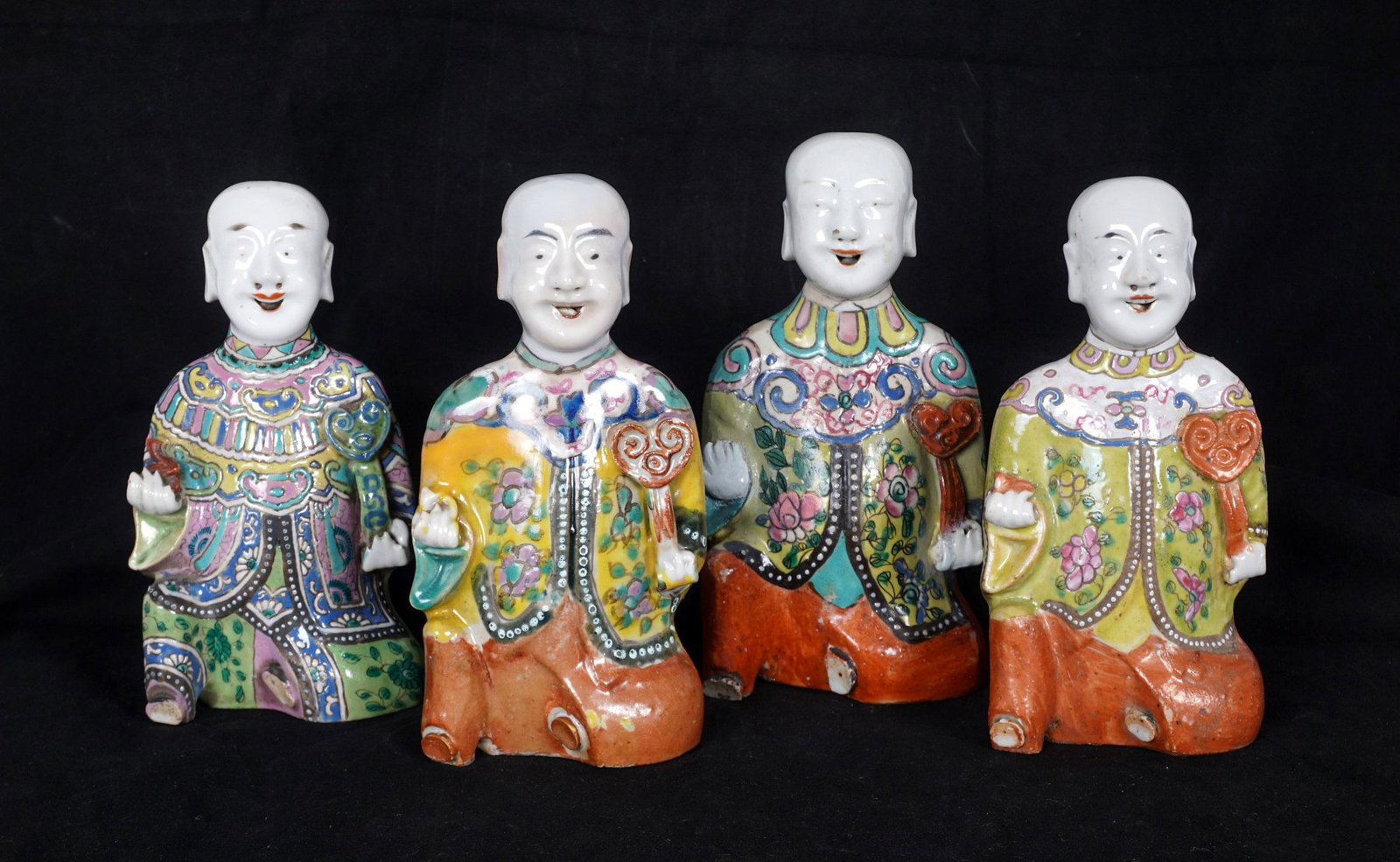 Four Chinese Porcelain Figural Incense Burners: A collection of four similar, but not identical, figures of seated Chinese figures holding a ruyi scepter, tallest measures 7 "h .x 4" x 2.25". Condition: Minor wear to decoration, one with repair to