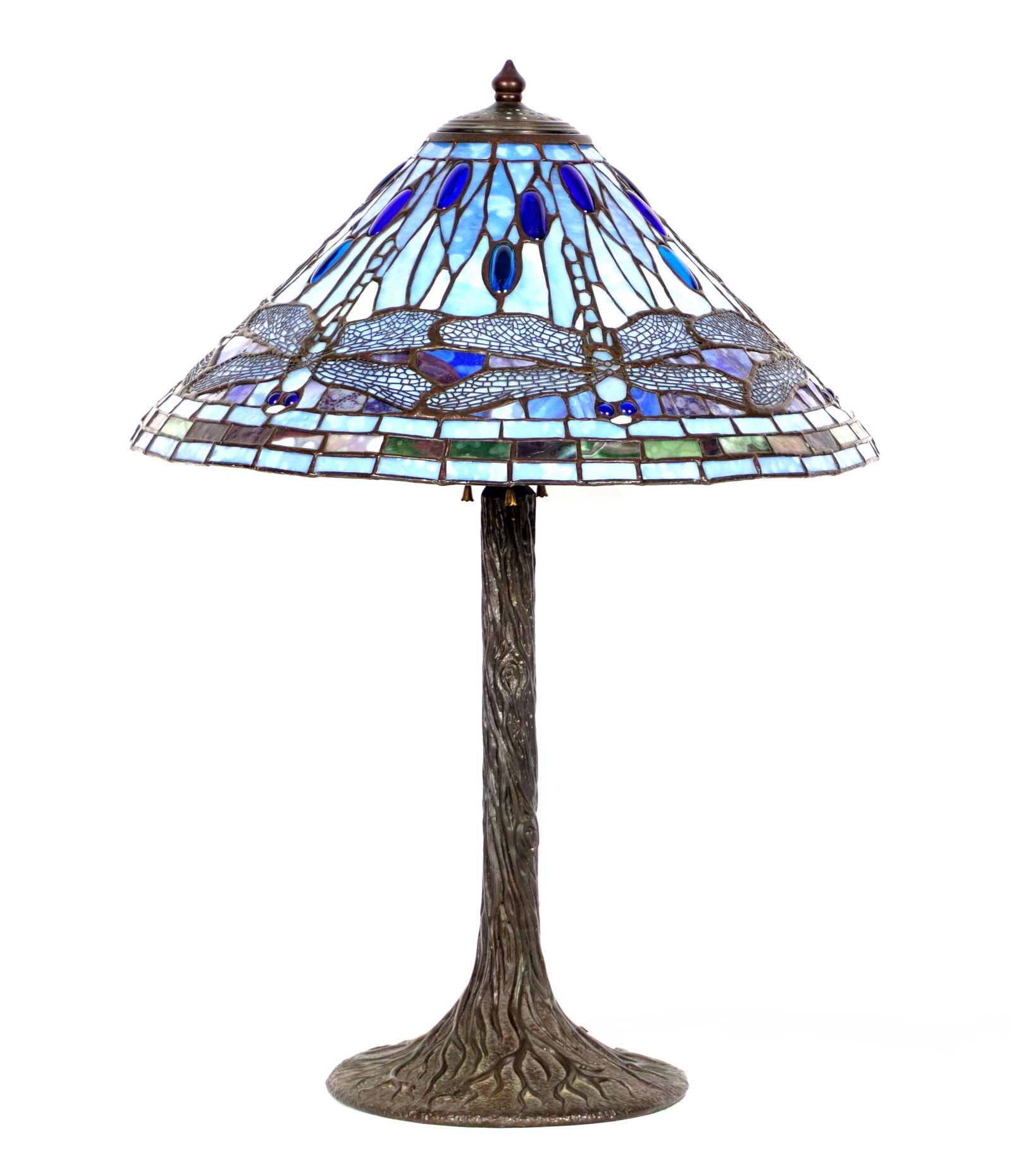 Tiffany Style Blue Dragonfly Leaded Glass Lamp: Tapered blue jeweled dragonfly motif leaded glass shade, bronze tree trunk form base, triple socket fixture, base 26" h .x 10.25", shade 8.75" x 20.25". From the estate of a prominent lawyer from New
