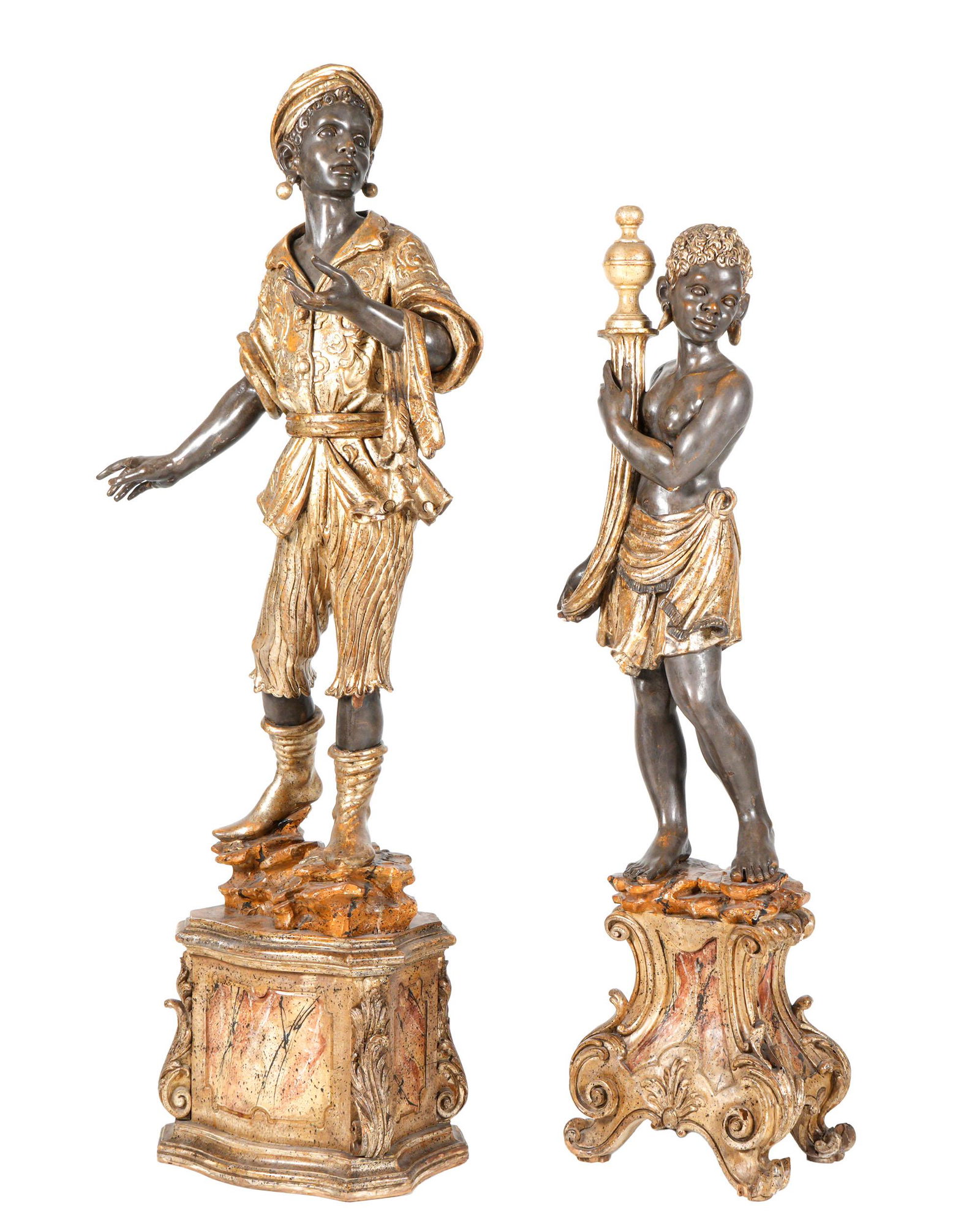 Two Carved Wood Blackamoor Figures: Two pieces total, 1) Figure of a standing man on carved base, 60.5" h. x 28" x 26.5". Note repairs to fingers, chips to paint. 2) Figure of a semi-nude woman on carved base, 53.75" h. x 17" x 11". Not