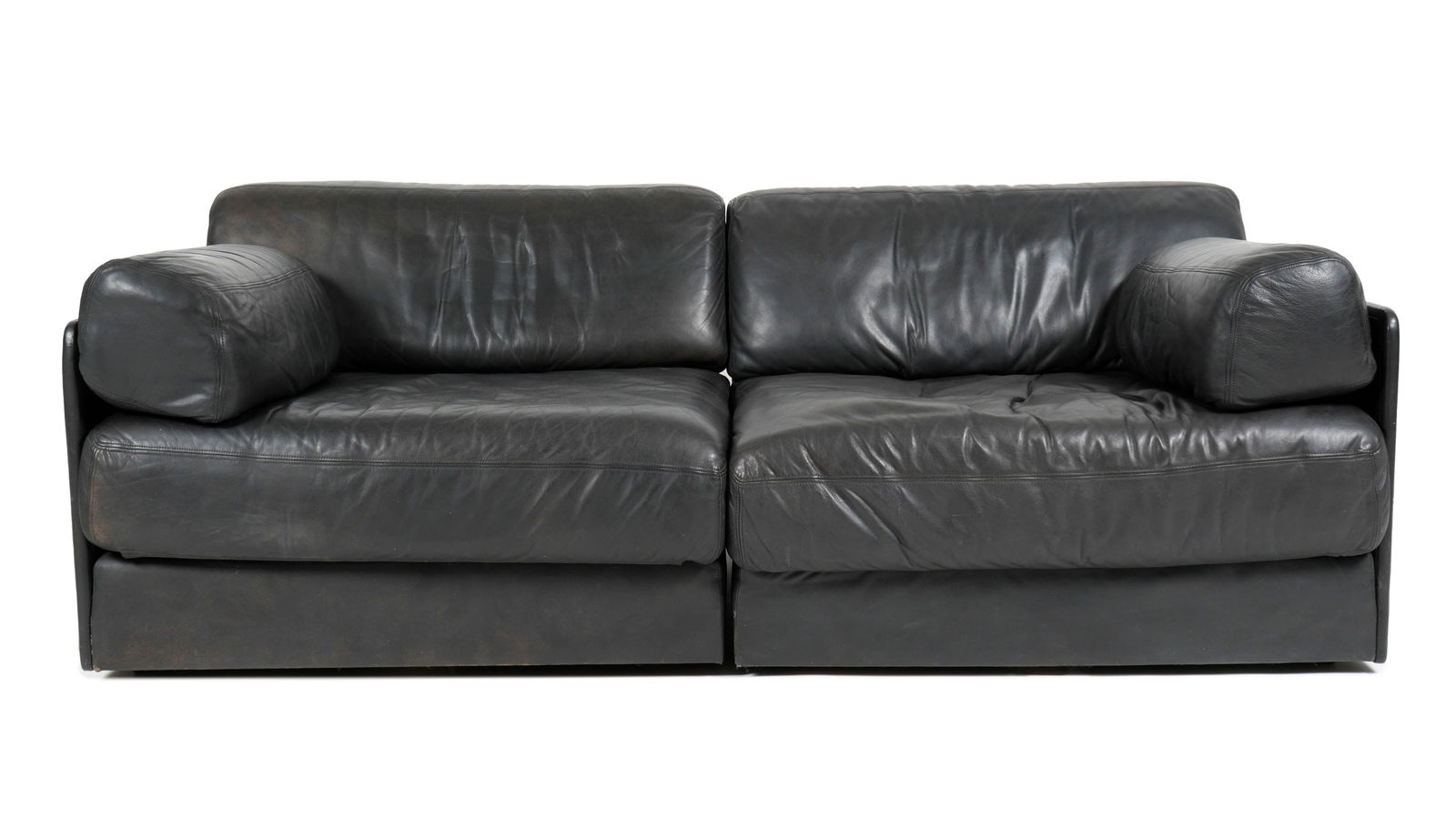 De Sede Black Leather DS-76 Modular Sofa: Two piece sectional black leather sofa by De Sede, model DS-76, well marked on fabric under seats and cushions. Each section 38' h. x 32" x 28". Condition: Blemishes to back, wear to leather consisten