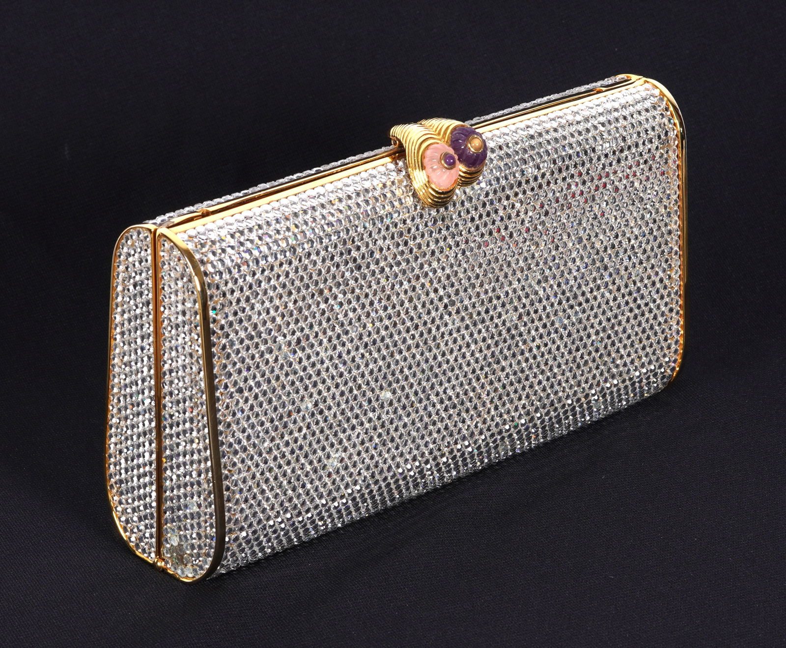 Judith Leiber Crystal Beaded Clutch / Handbag: Clutch purse beaded all over, clasp with carved stone accents, gold toned trim. Interior with mirror and gold toned strap. Sold with original Neiman Marcus receipt for $1100, and Leiber dust bag. 4.25