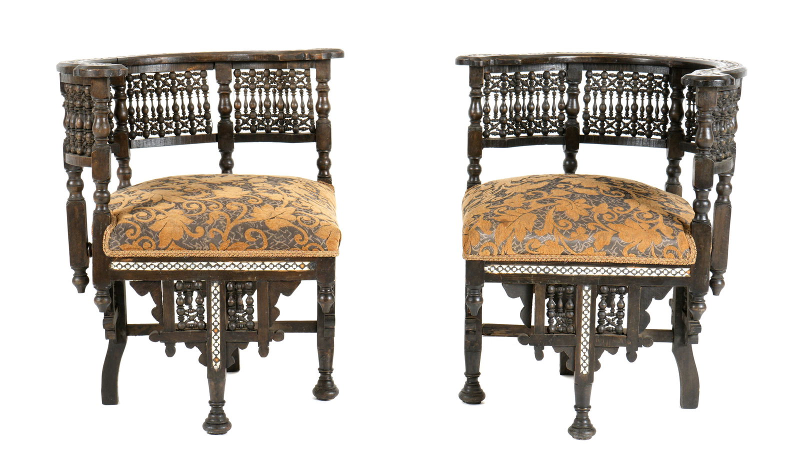 Pair Middle Eastern Persian / Moorish Inlaid Chairs: Pair corner chairs, each with inlaid shaped top rail over arabesque turned spindle gallery back,. Inlaid skirt over conforming decorated legs, floral patterned upholstery. Overall 29" h. x 28.5" x 28"