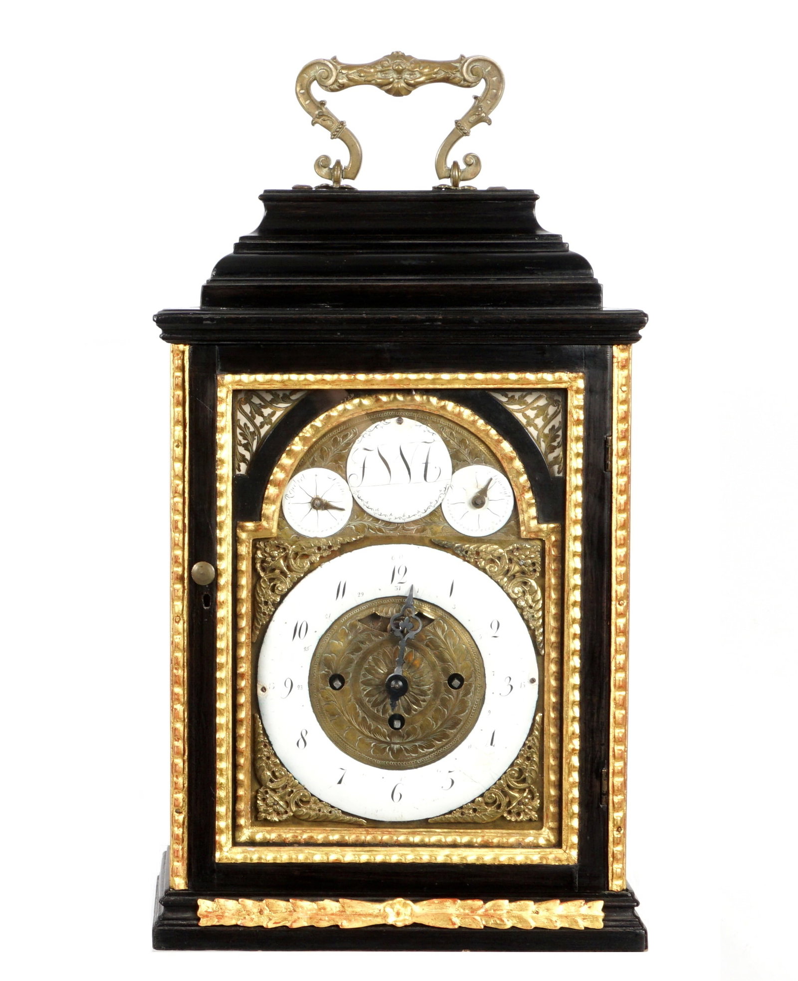 18th/19th Century Ebonized Gilt Wood Cabinet Clock: Late 18th to early 19th century, ebonized wood case with carved gilt accents, bronze handle finial. Mixed metal brass dial, enamel chapter ring with time and date Arabic numerals. Three additional ena